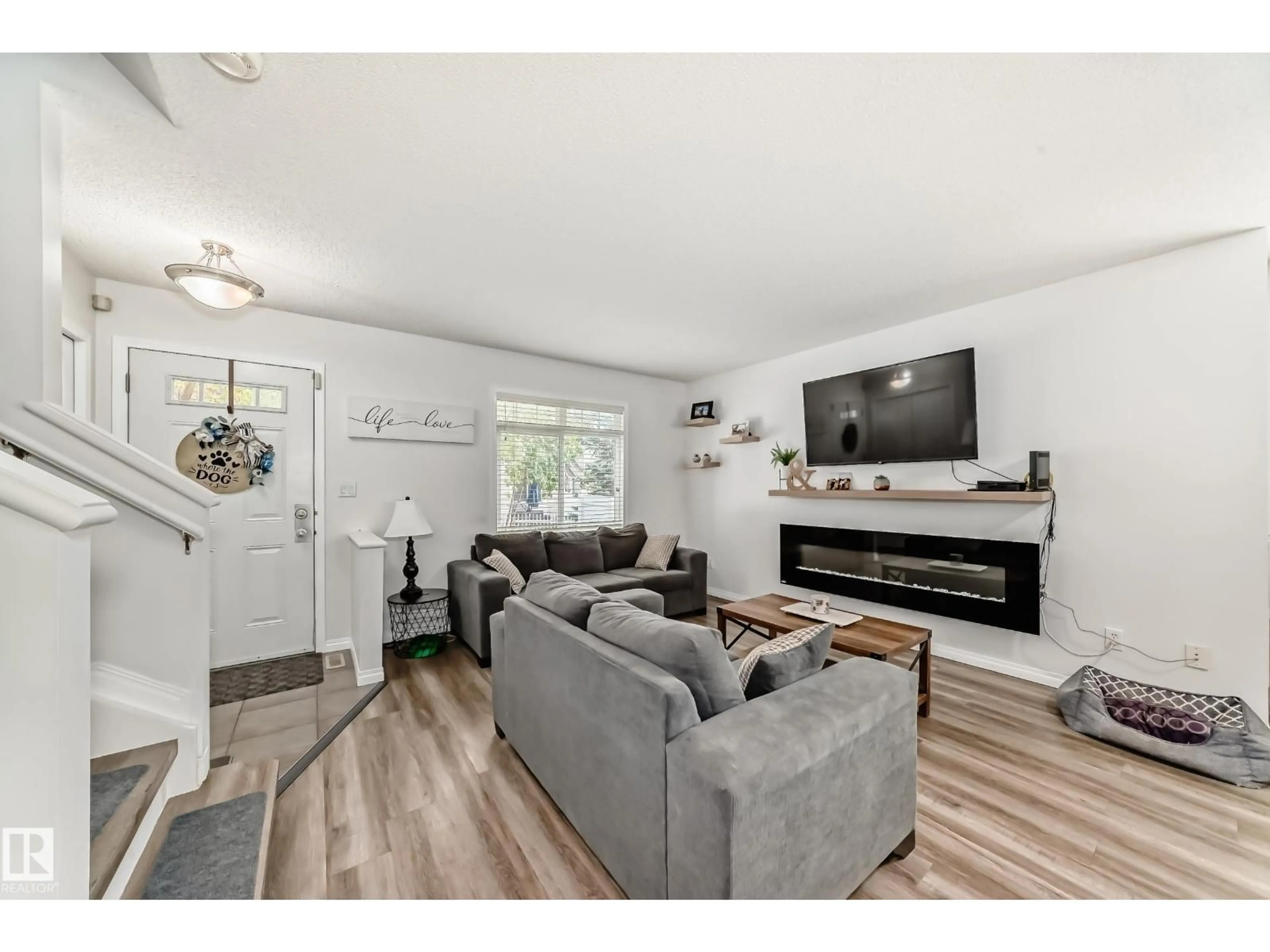 Living room with furniture, wood/laminate floor for 186 - 1804 70 ST, Edmonton Alberta T6X0H4