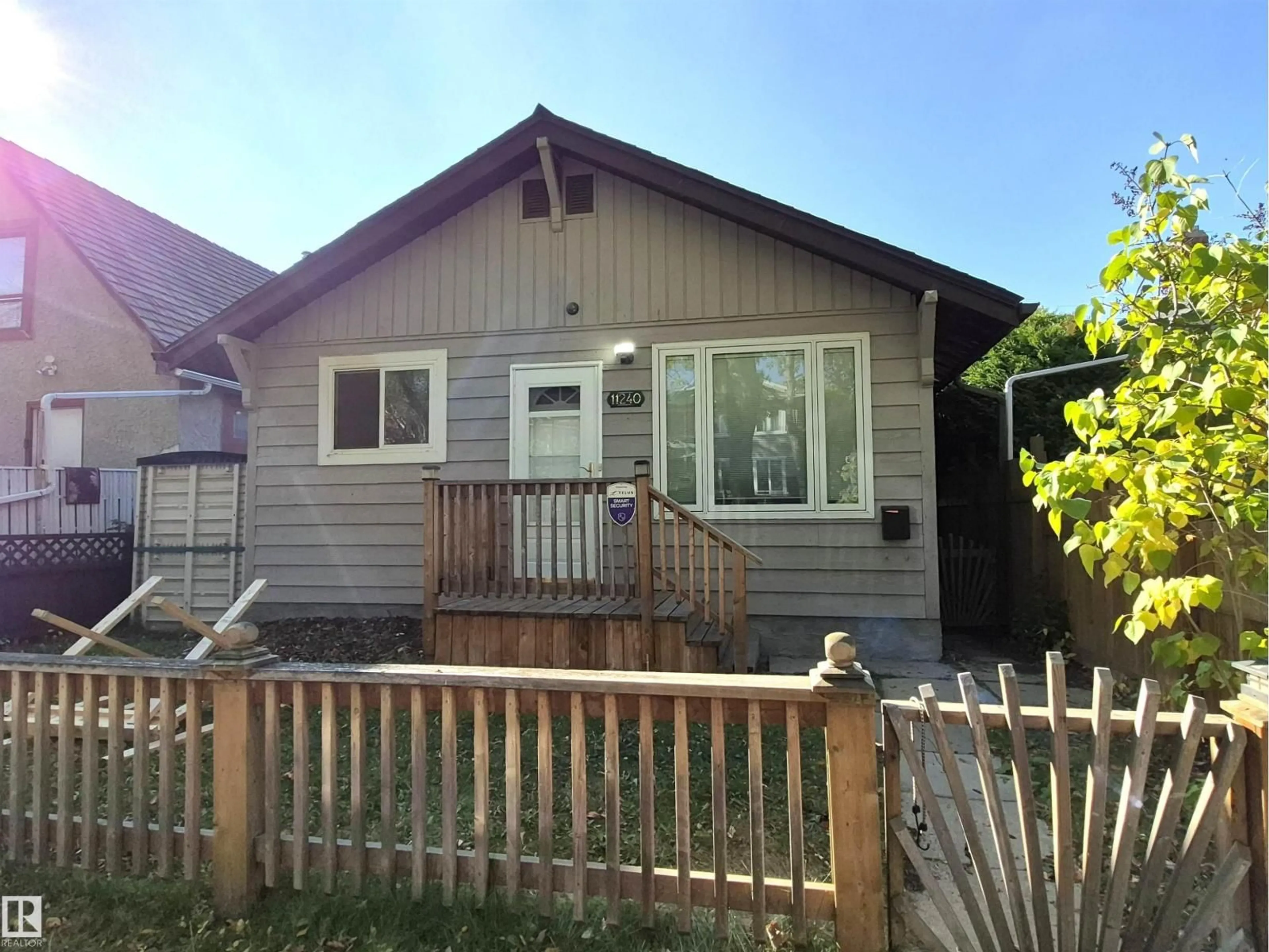 Home with vinyl exterior material, street for 11240 94 ST, Edmonton Alberta T5G1G9