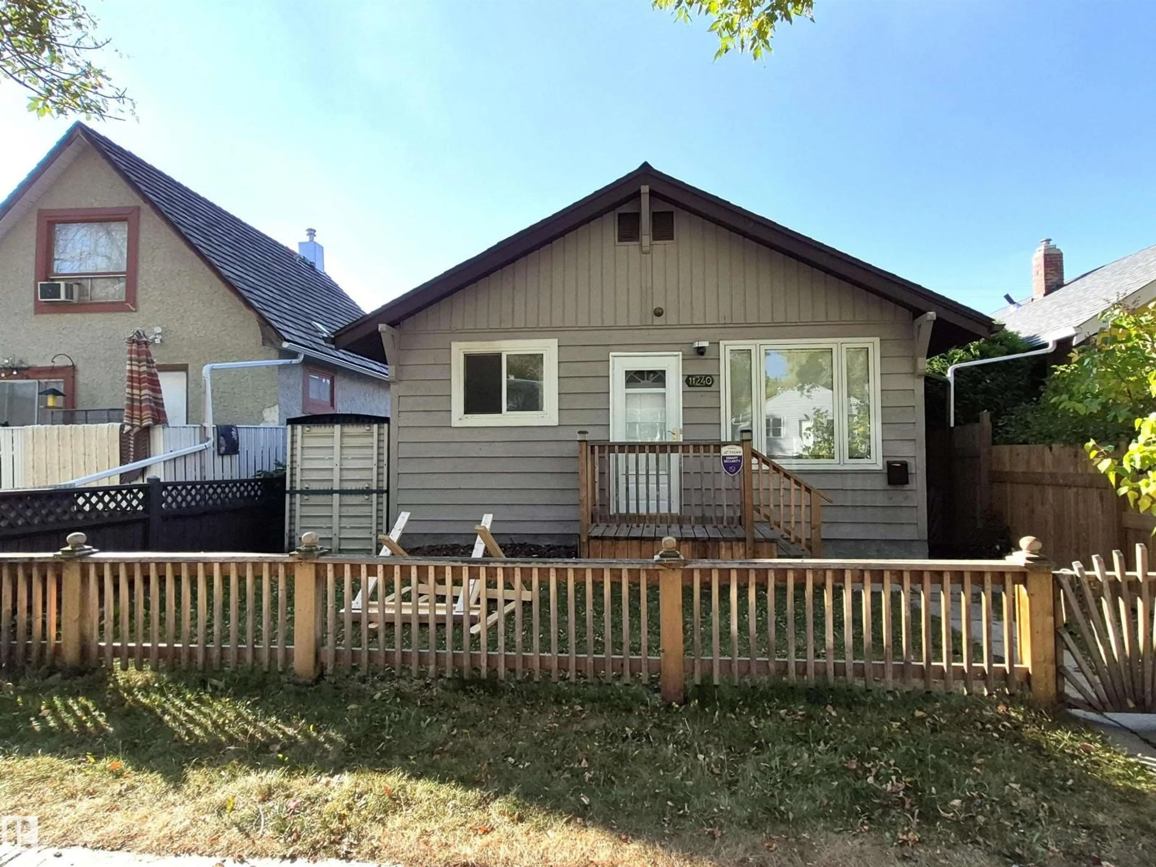 Home with vinyl exterior material, street for 11240 94 ST, Edmonton Alberta T5G1G9