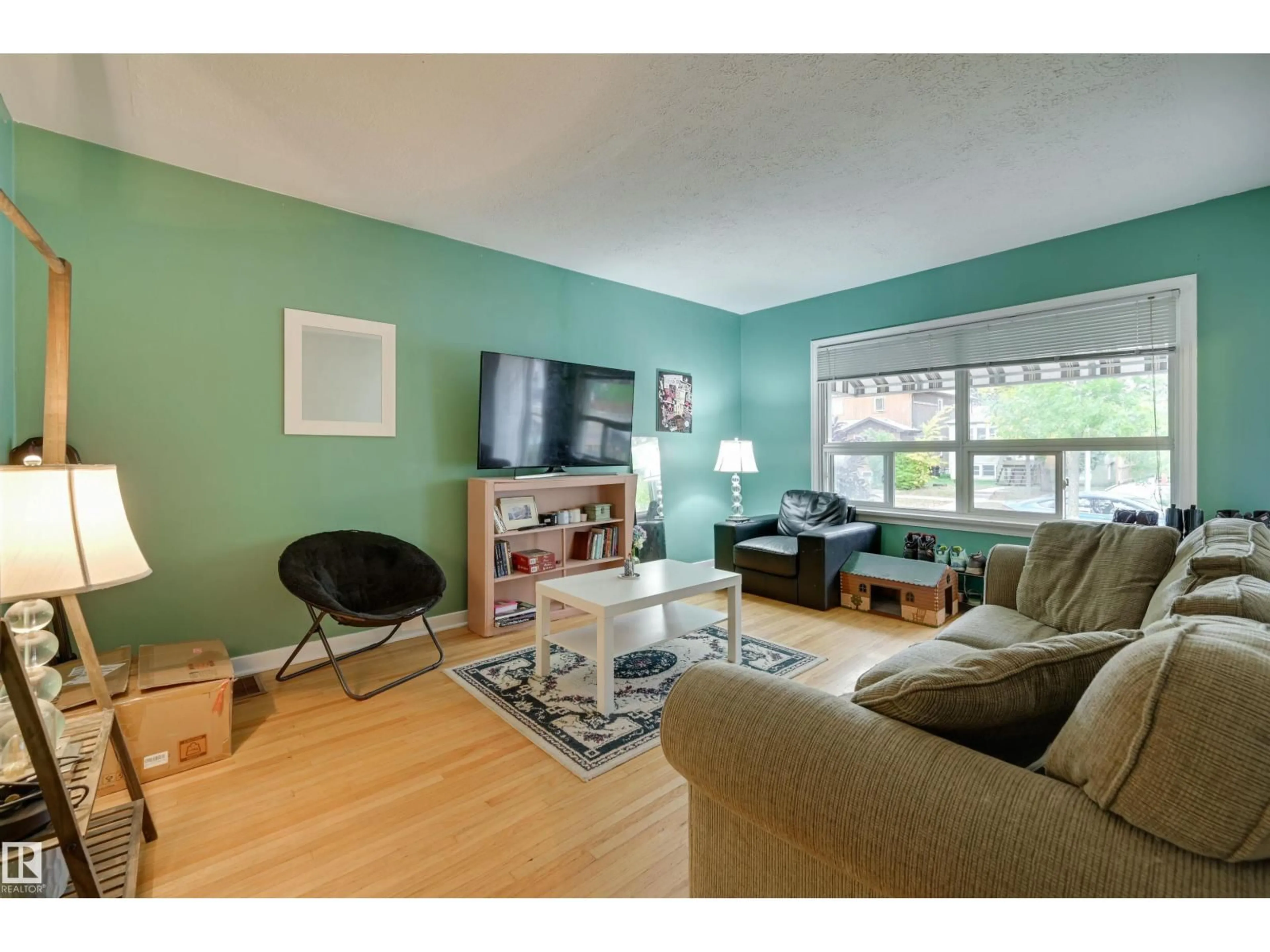 Living room with furniture, wood/laminate floor for 10752 75 AV, Edmonton Alberta T6E1J9