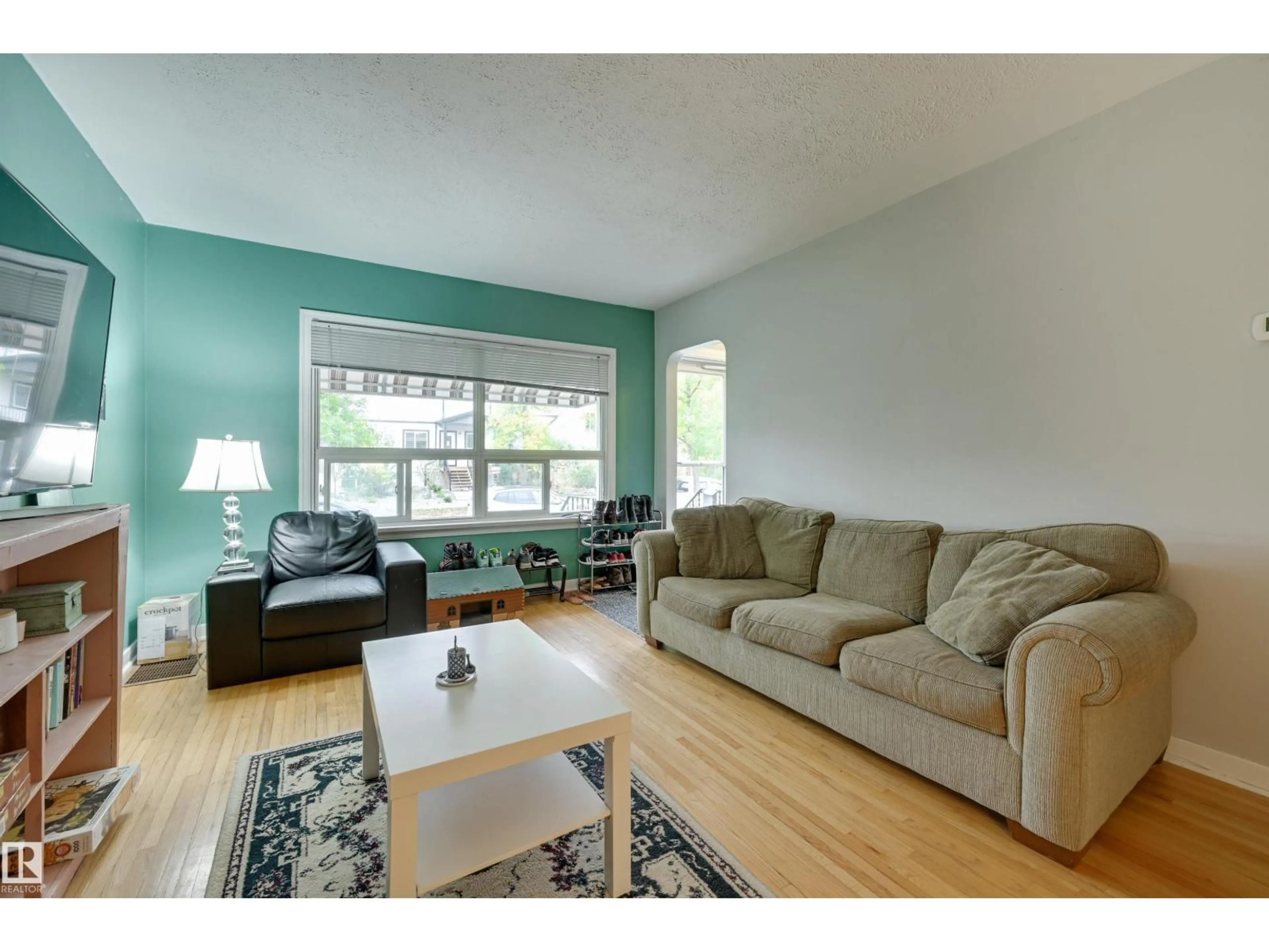 Living room with furniture, wood/laminate floor for 10752 75 AV, Edmonton Alberta T6E1J9