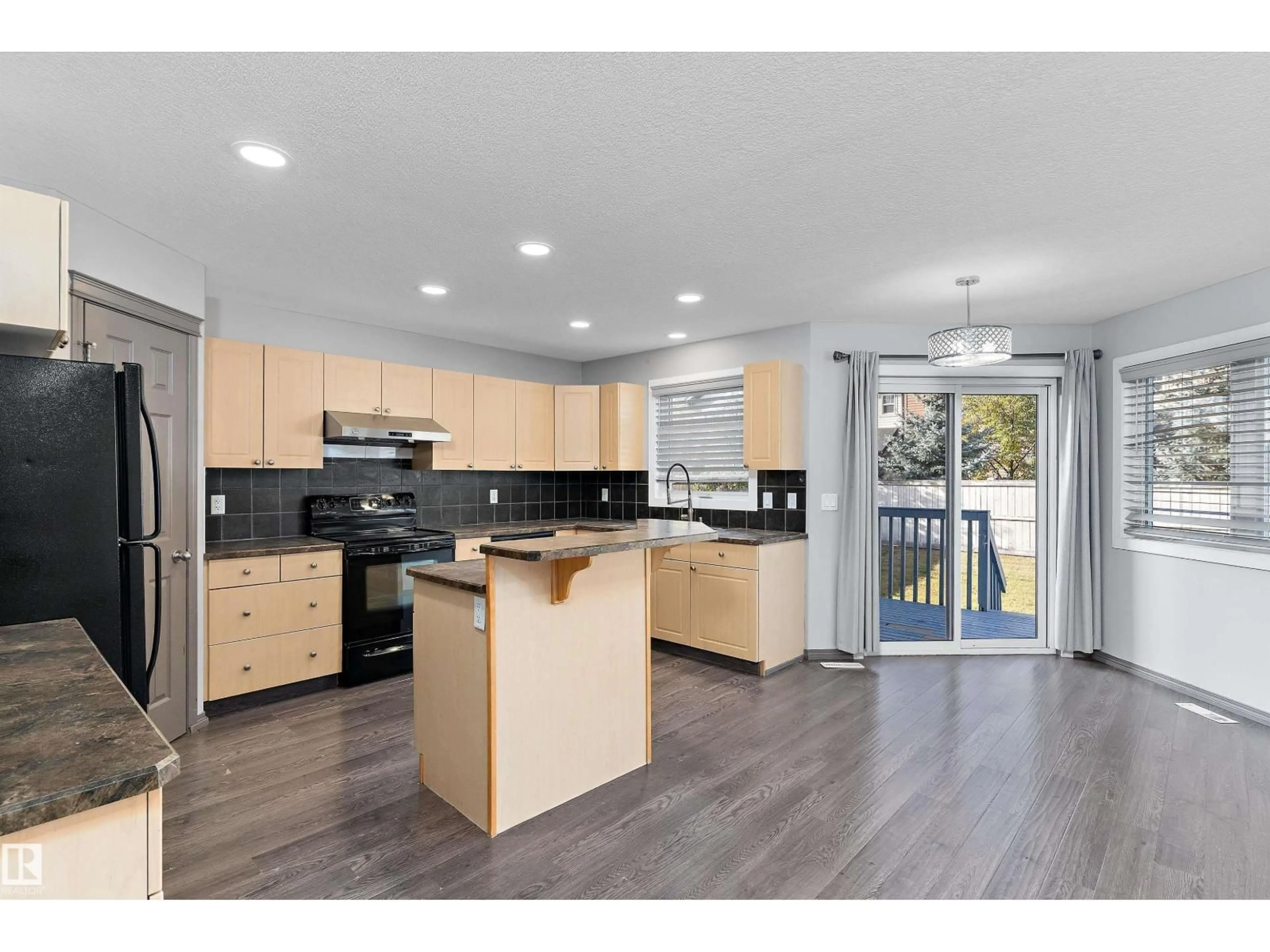 Open concept kitchen, wood/laminate floor for 8736 178 AV, Edmonton Alberta T5Z0B8