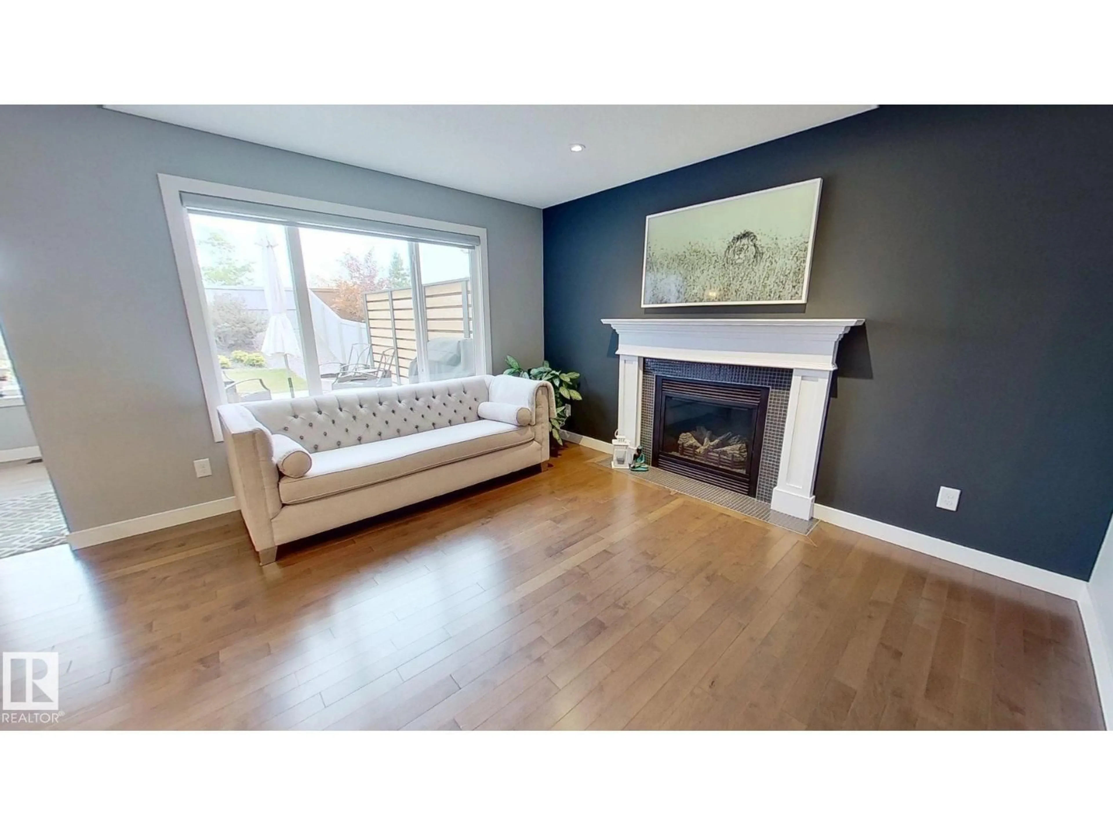 Living room with furniture, wood/laminate floor for 122 SUNTERRA WY, Sherwood Park Alberta T8H0T8