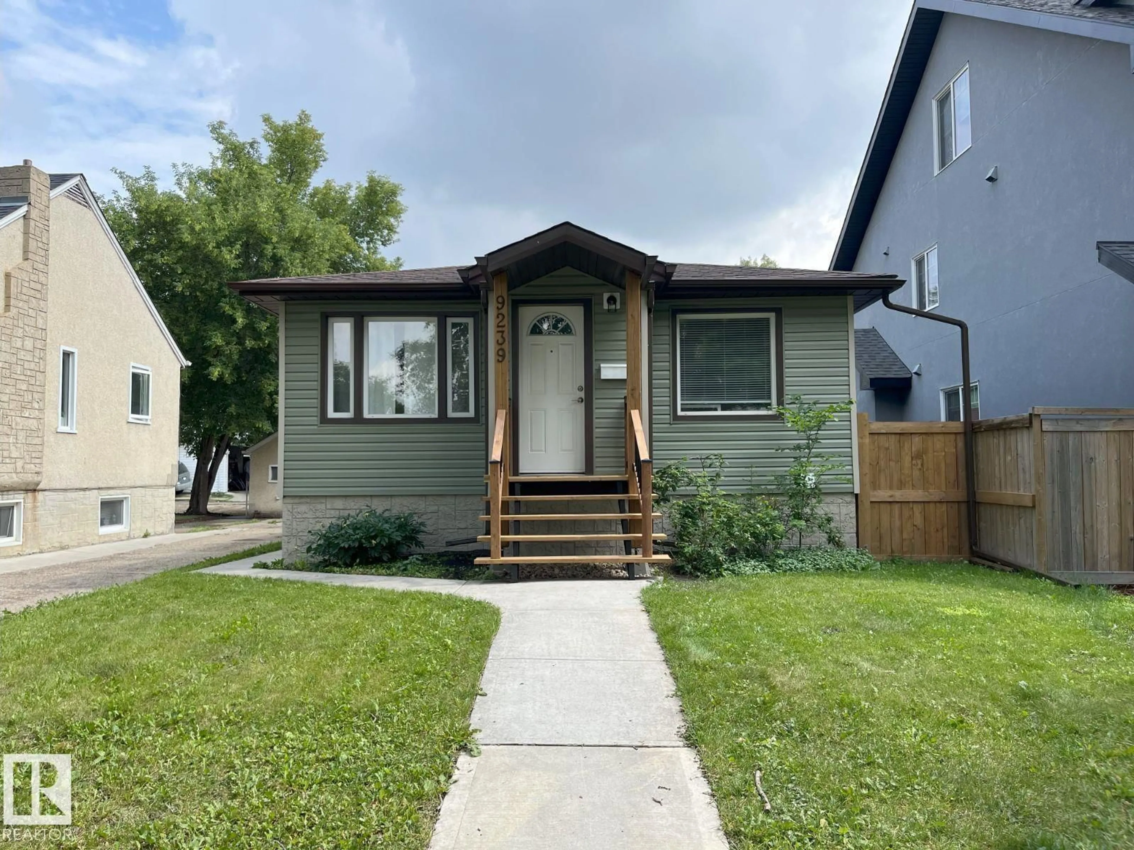 Home with vinyl exterior material, street for 9239 92 ST, Edmonton Alberta T6C3R4