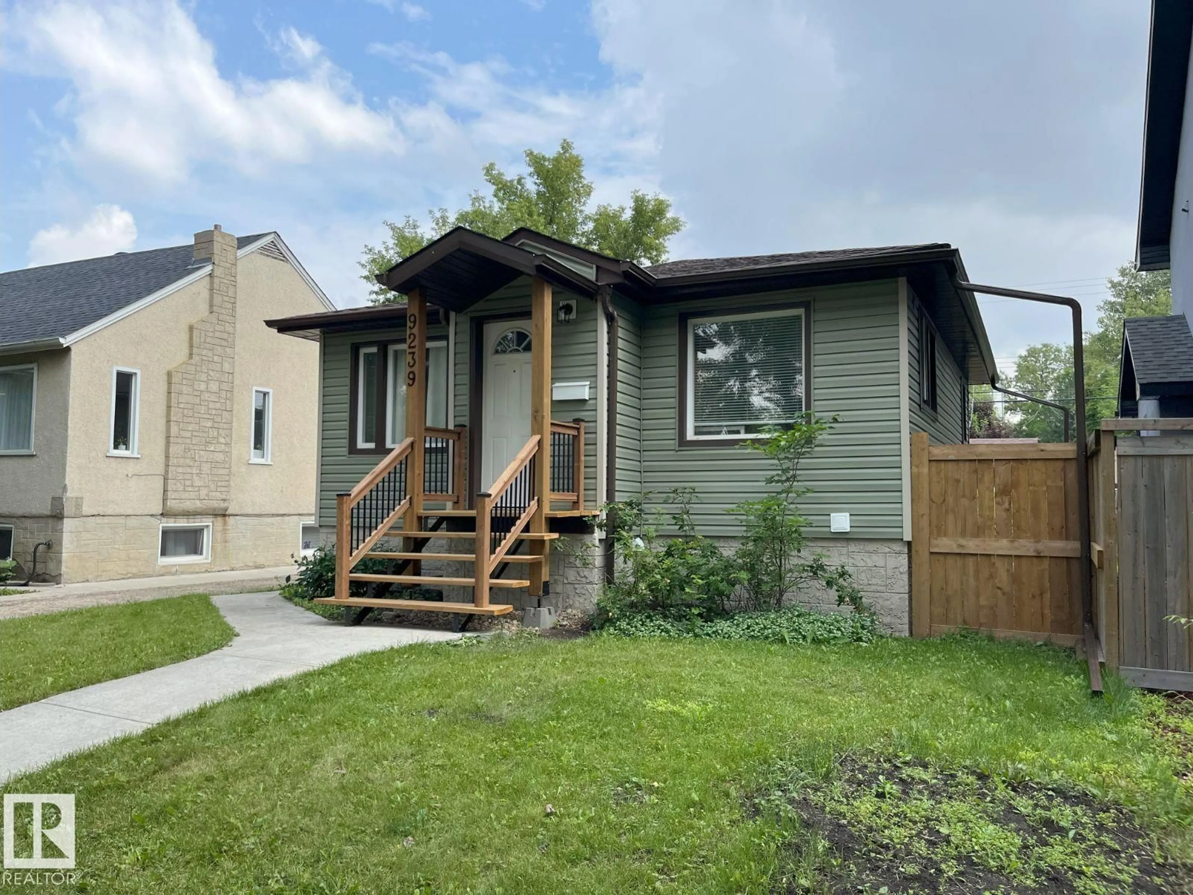 Home with vinyl exterior material, street for 9239 92 ST, Edmonton Alberta T6C3R4