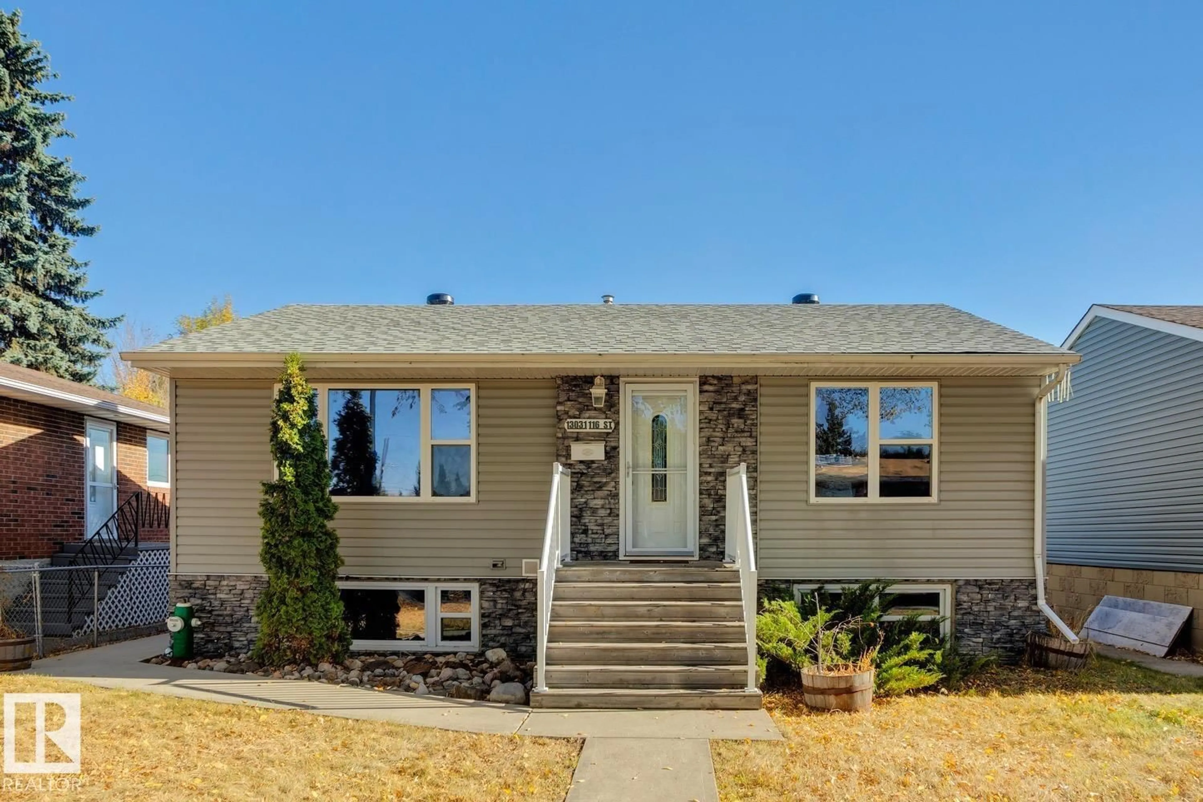 Home with vinyl exterior material, street for NW - 13031 116 ST, Edmonton Alberta T5E5H6