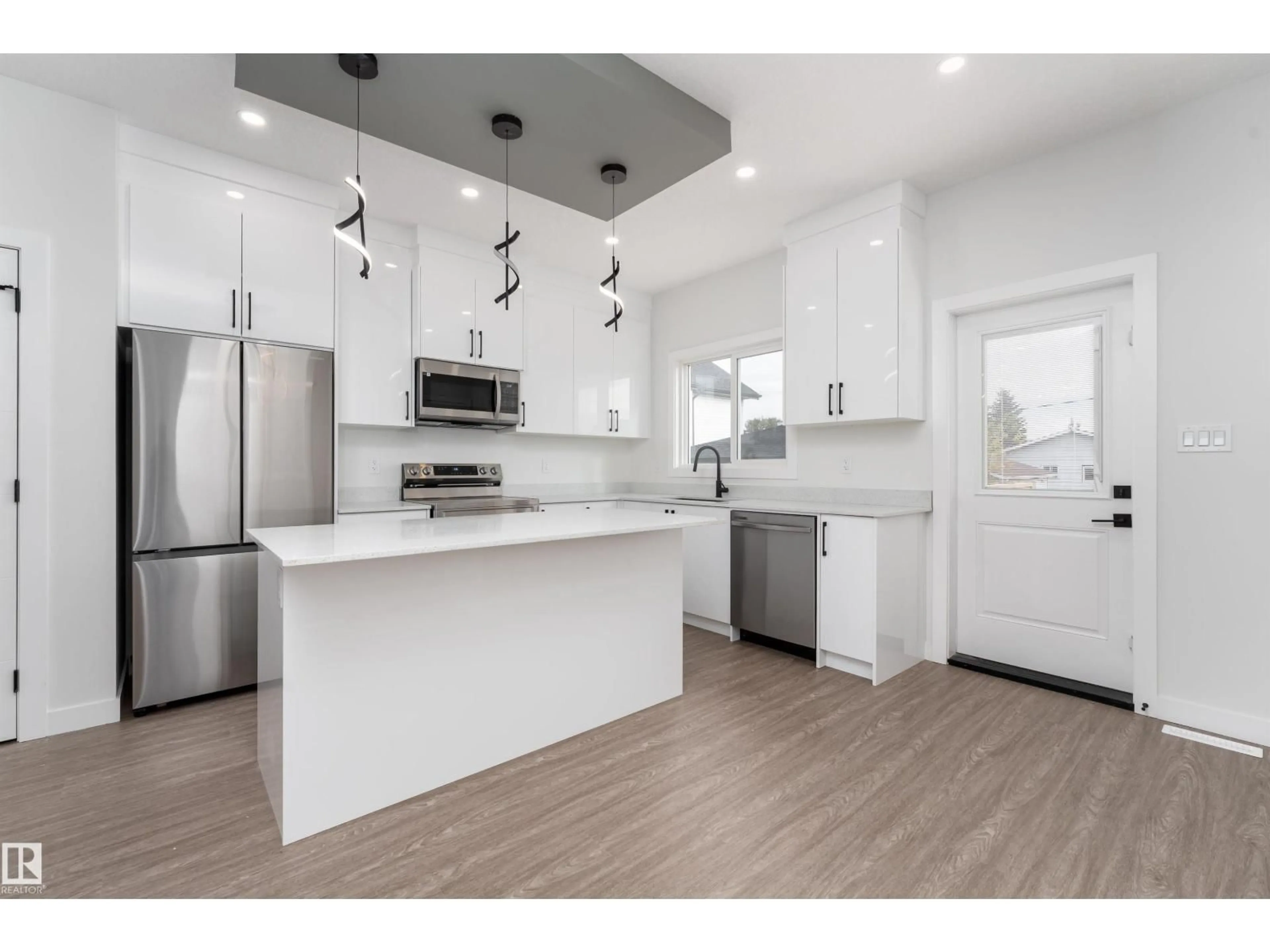 Open concept kitchen, wood/laminate floor for 12431 47 ST, Edmonton Alberta T5W5E5