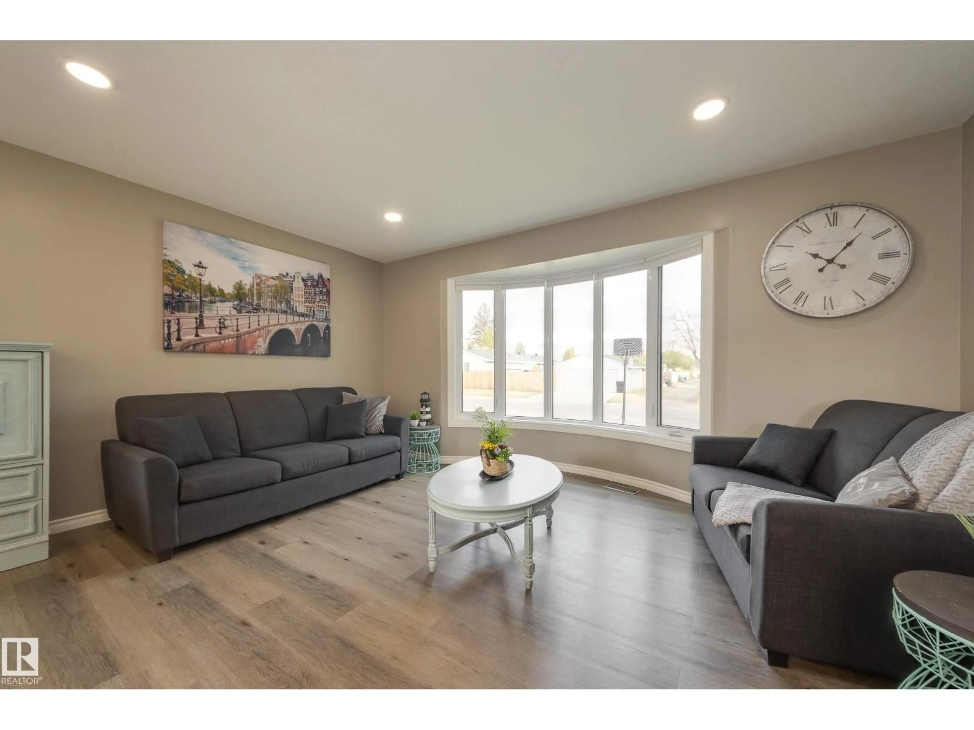 Living room with furniture, wood/laminate floor for 16107 80 AV, Edmonton Alberta T5R3M5