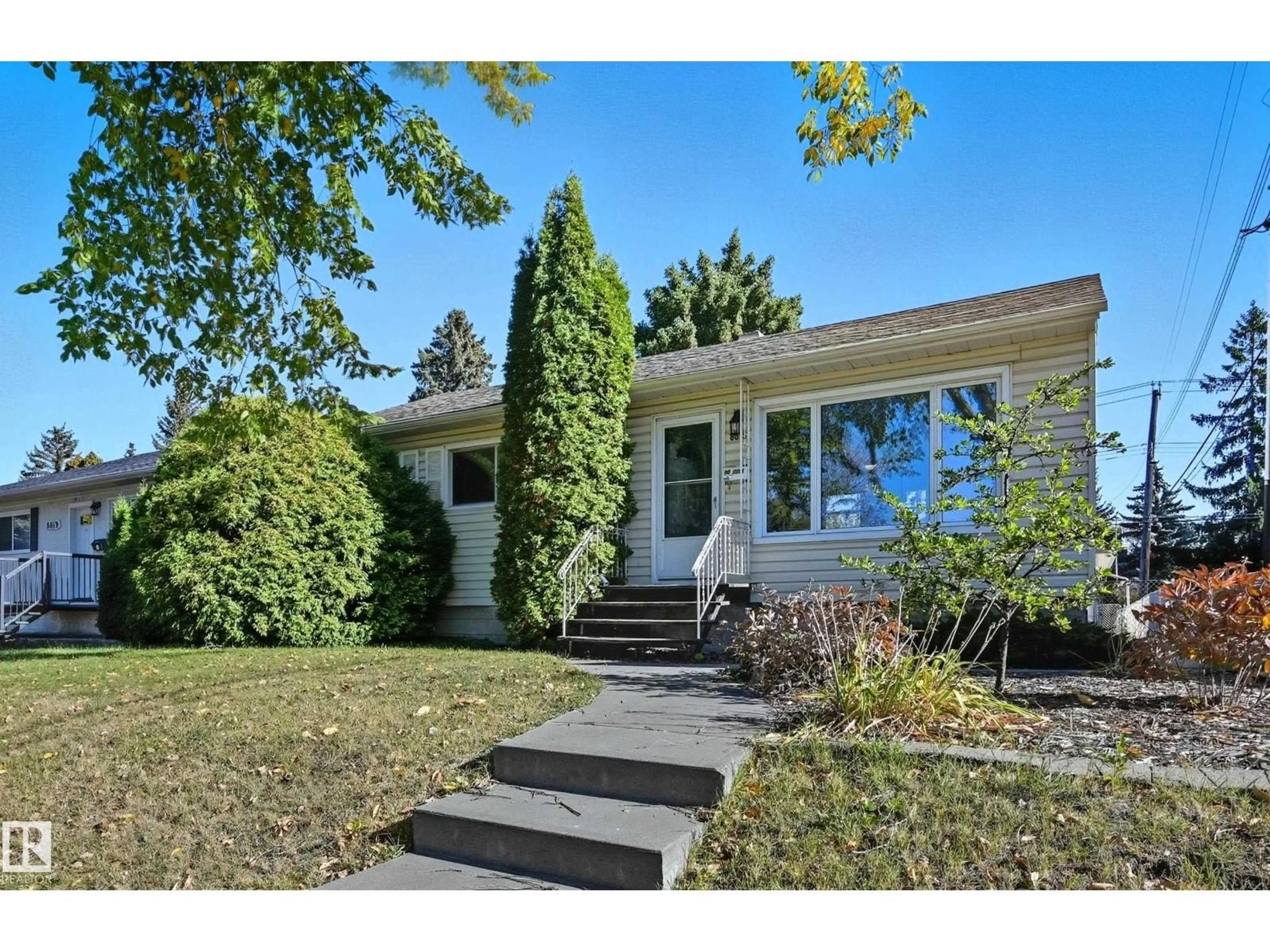 Home with vinyl exterior material, street for NW - 8815 76 ST, Edmonton Alberta T6C2K1
