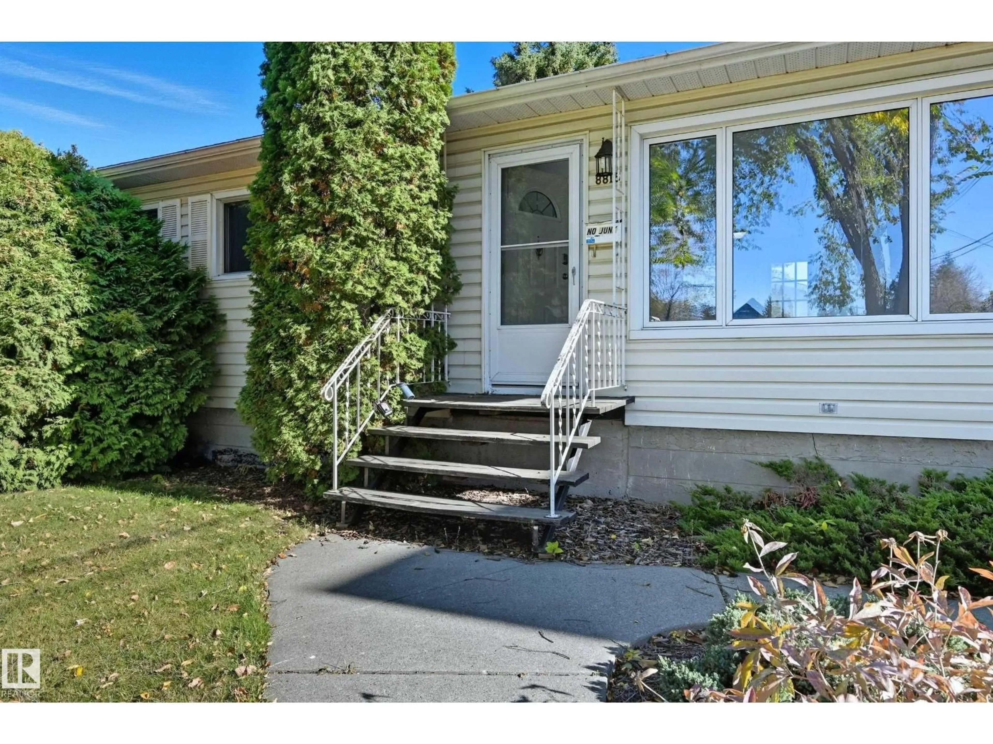 Home with vinyl exterior material, street for NW - 8815 76 ST, Edmonton Alberta T6C2K1