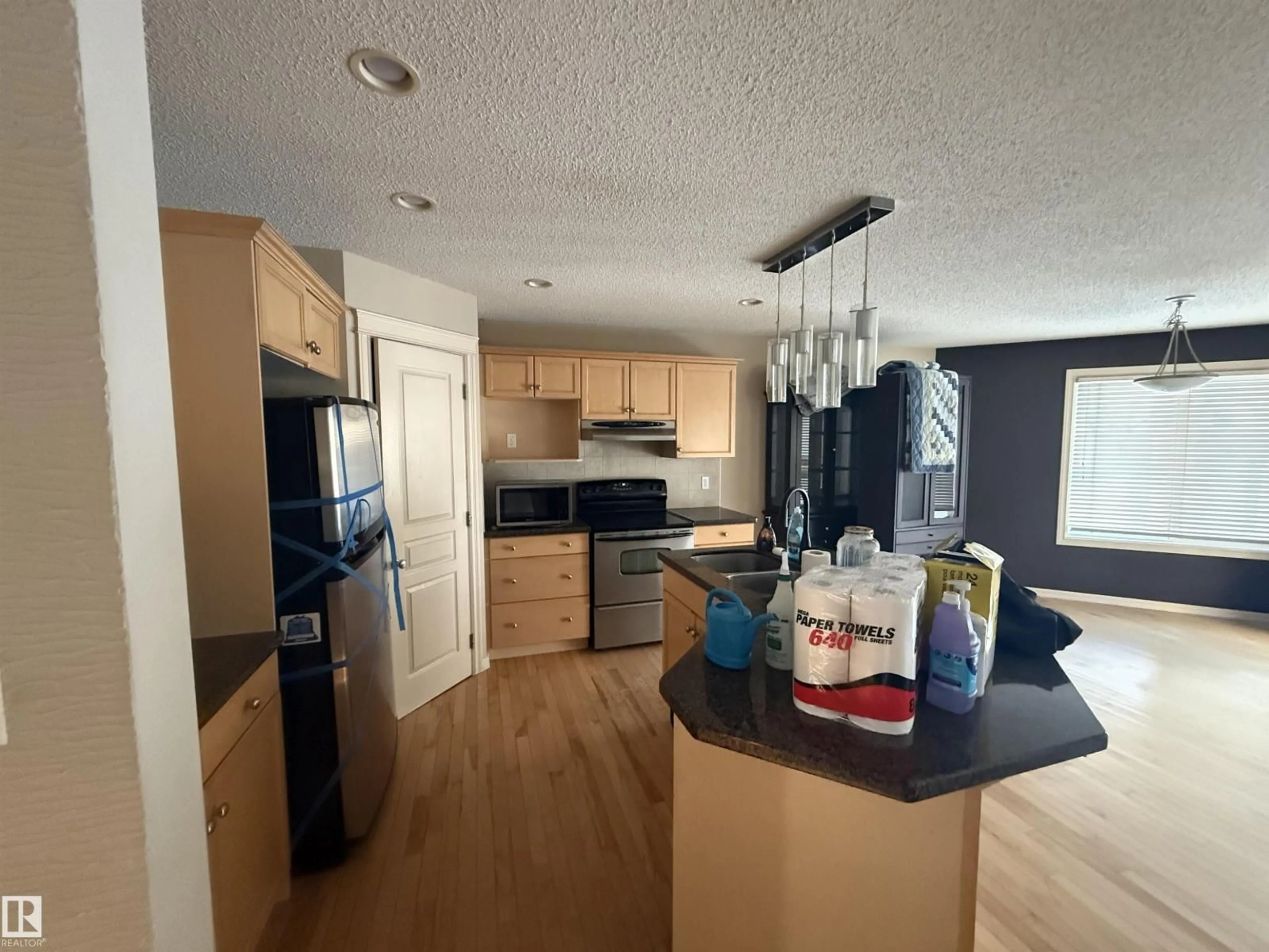 Open concept kitchen, wood/laminate floor for SW - 6007 5 AV, Edmonton Alberta T6X0E8