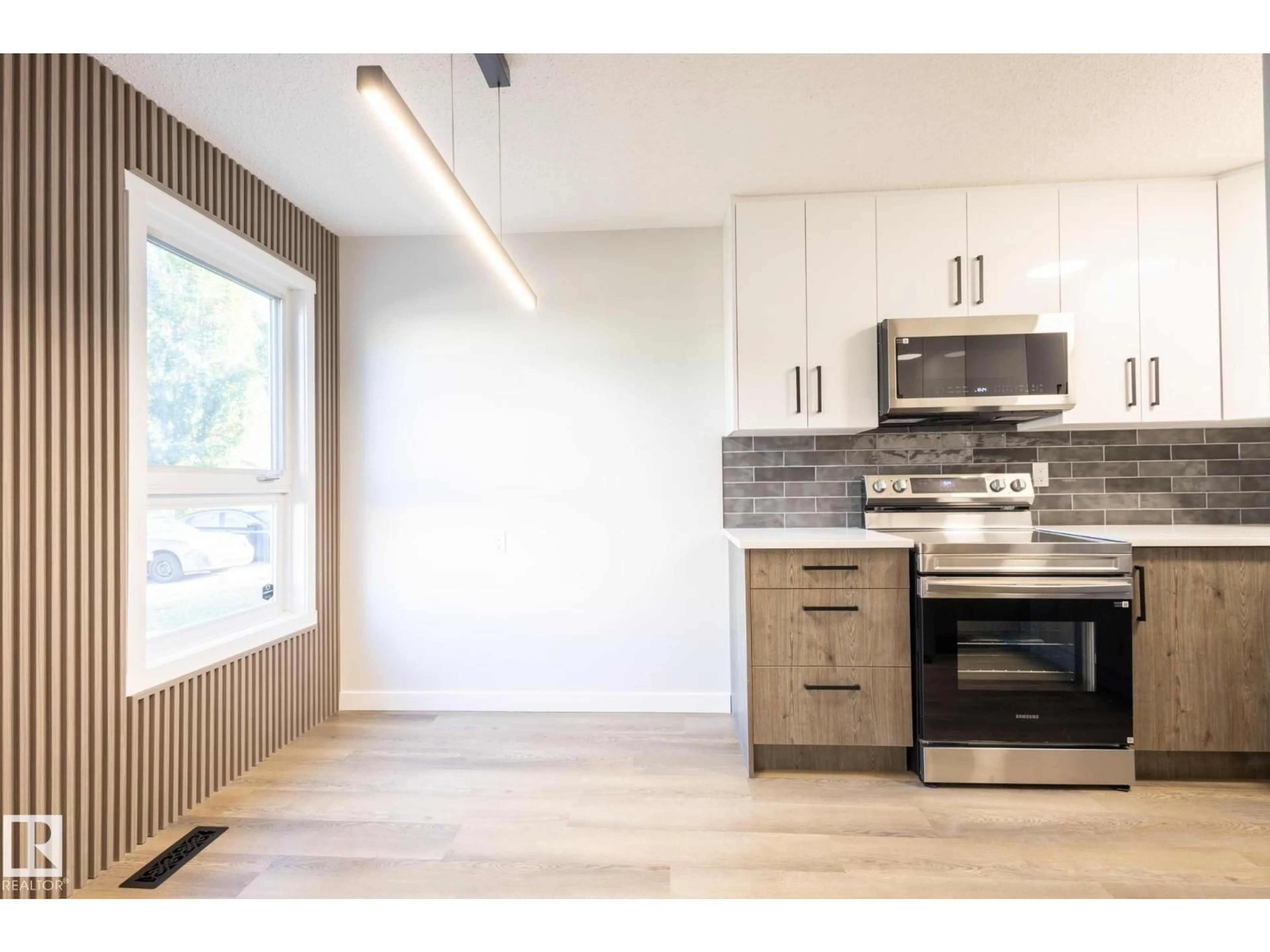 Open concept kitchen, wood/laminate floor for 14035 121 ST, Edmonton Alberta T5X4H8