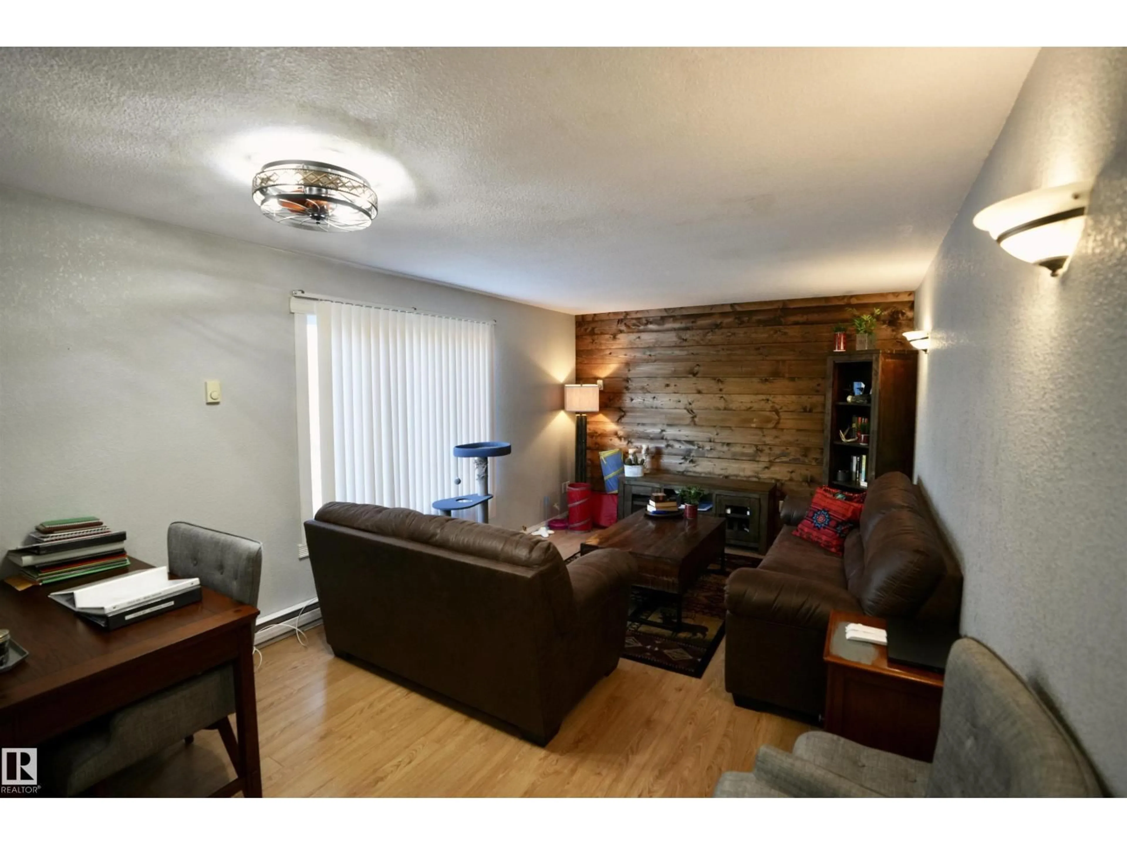 Living room with furniture, wood/laminate floor for 136 - 11124 TWP RD 595, Rural St. Paul County Alberta T0A0C0