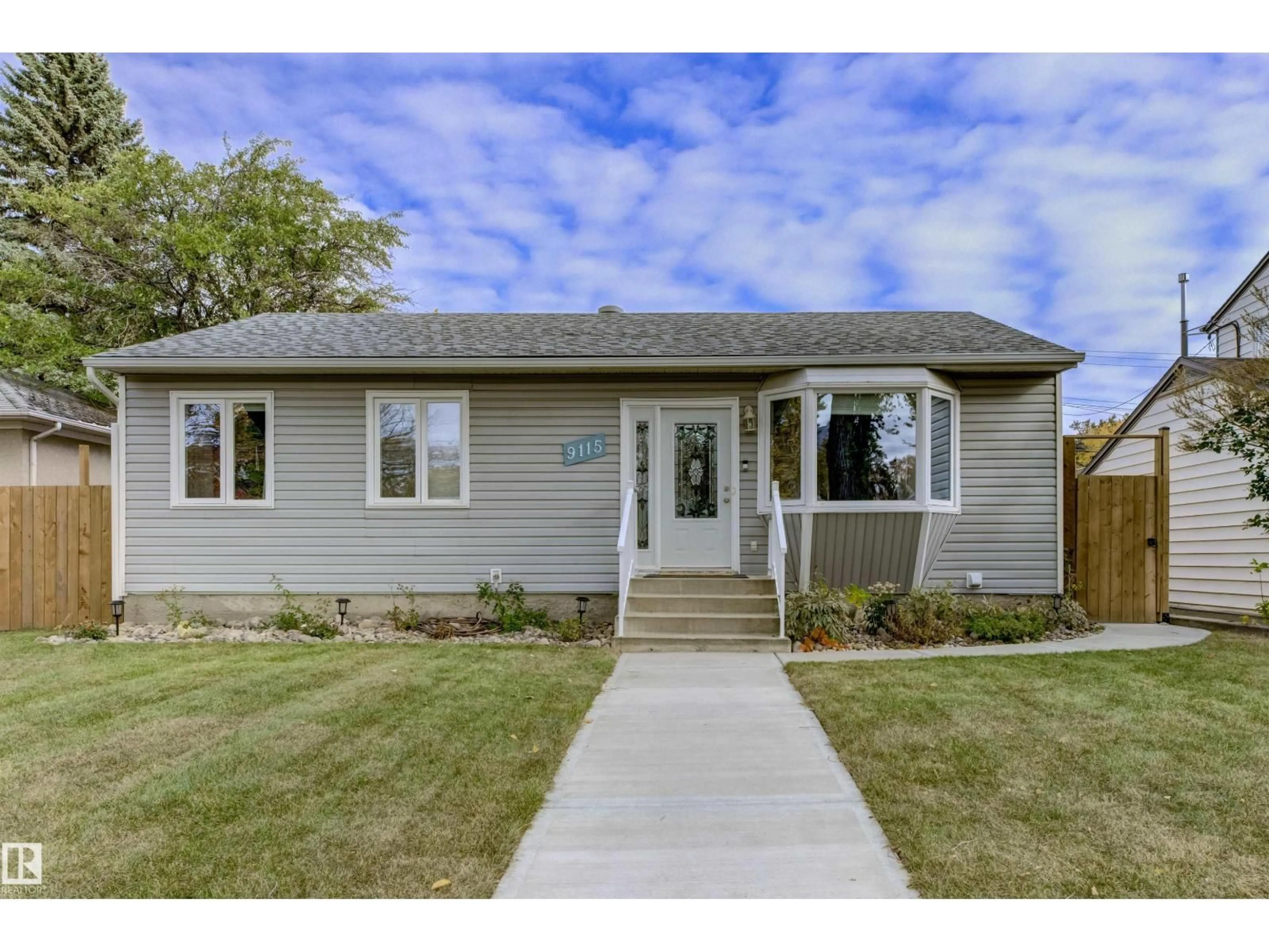 Home with vinyl exterior material, street for 9115 79 ST, Edmonton Alberta T6C2R3