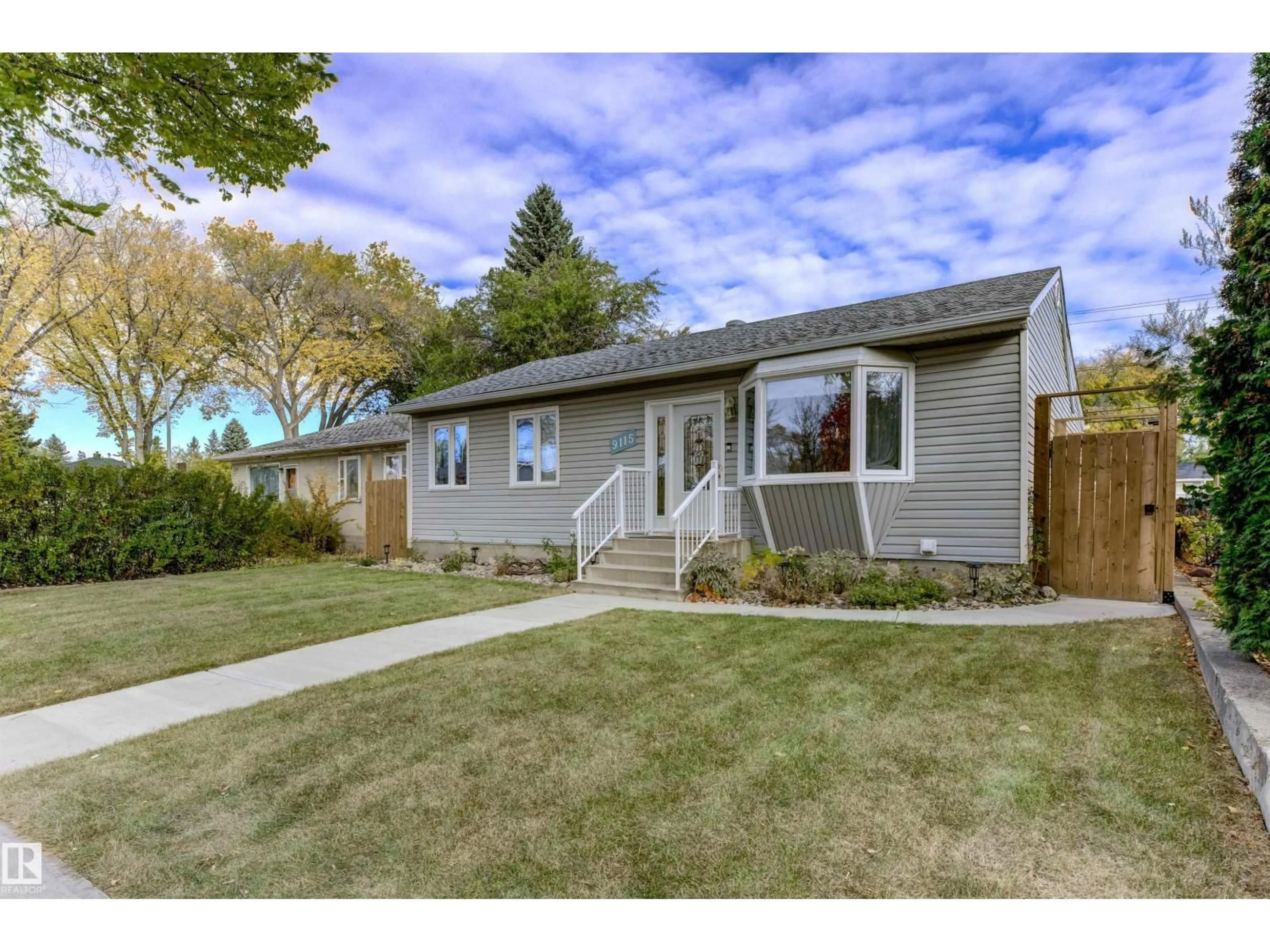 Home with vinyl exterior material, street for 9115 79 ST, Edmonton Alberta T6C2R3