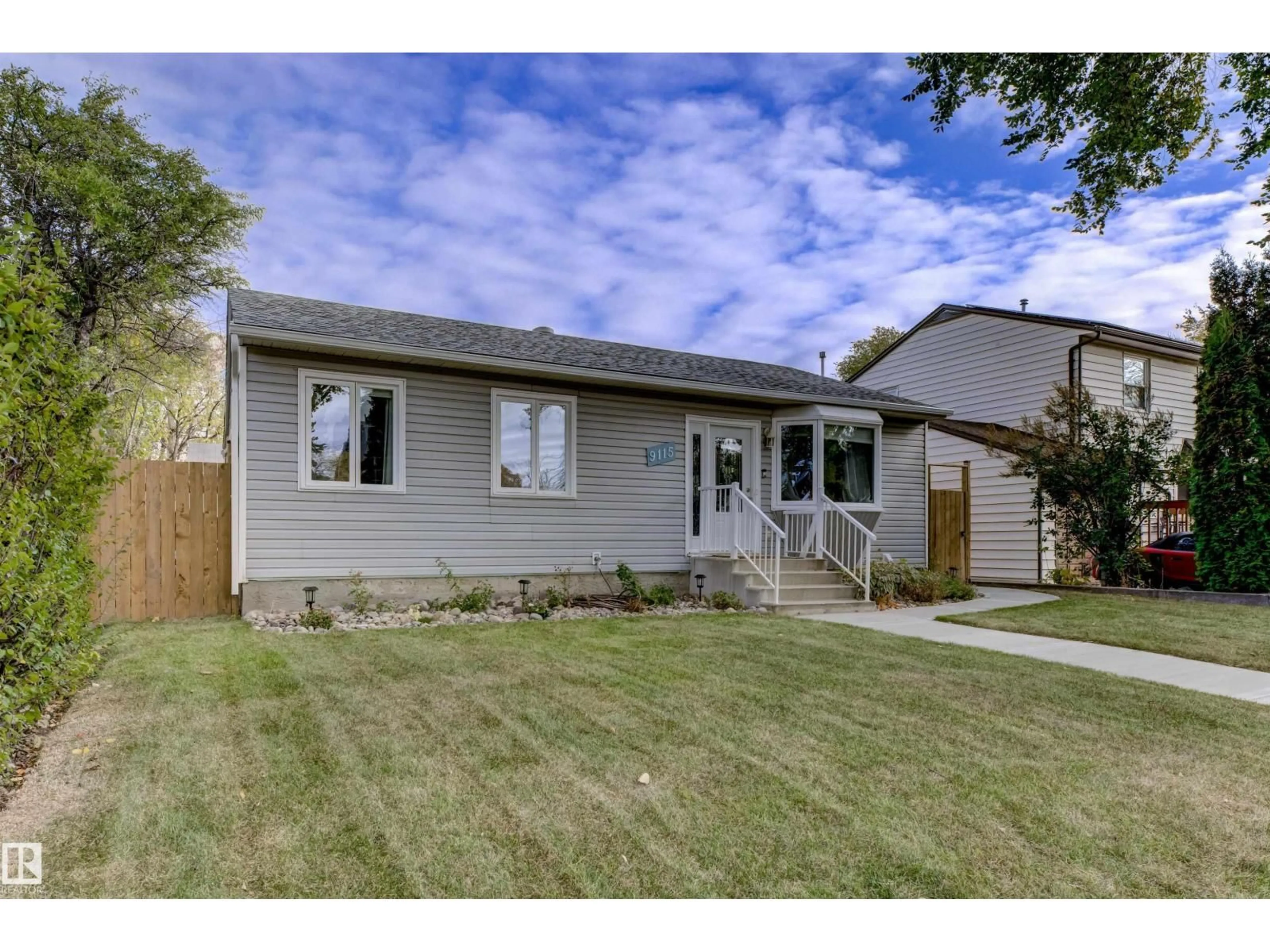 Home with vinyl exterior material, street for 9115 79 ST, Edmonton Alberta T6C2R3