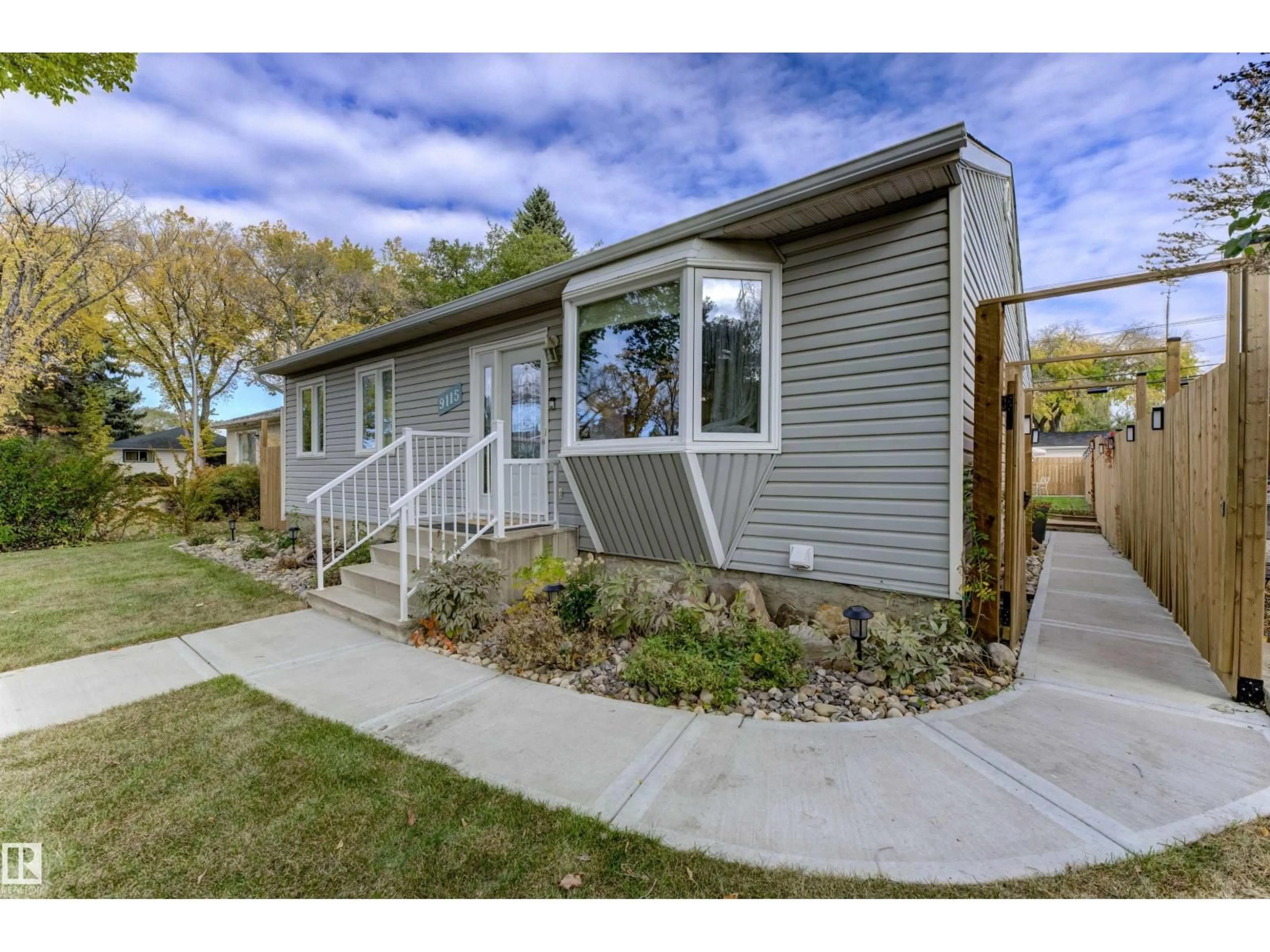 Home with vinyl exterior material, street for 9115 79 ST, Edmonton Alberta T6C2R3