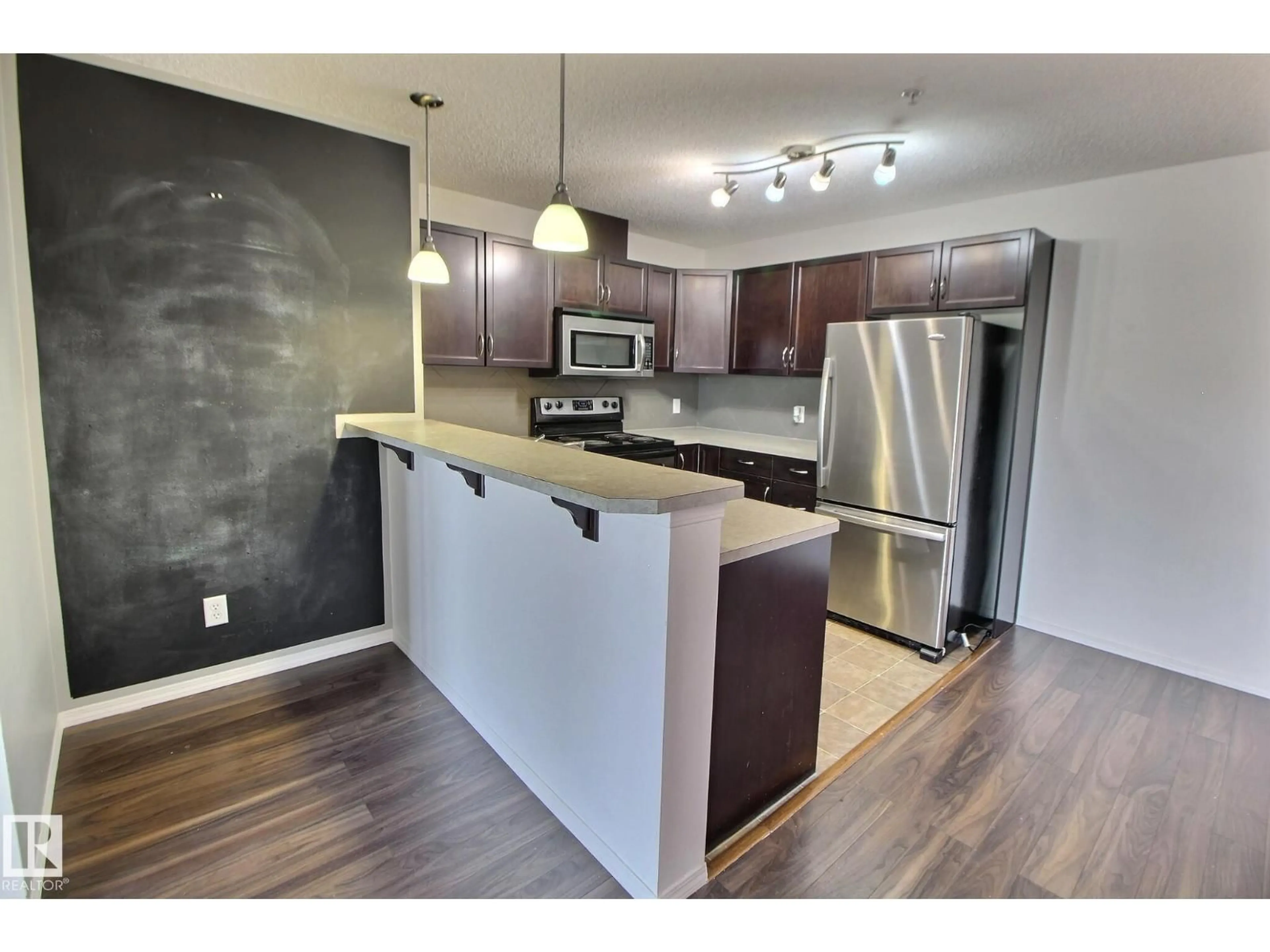 Open concept kitchen, wood/laminate floor for 205 5951 165 AV NW, Edmonton Alberta T5Y0J6