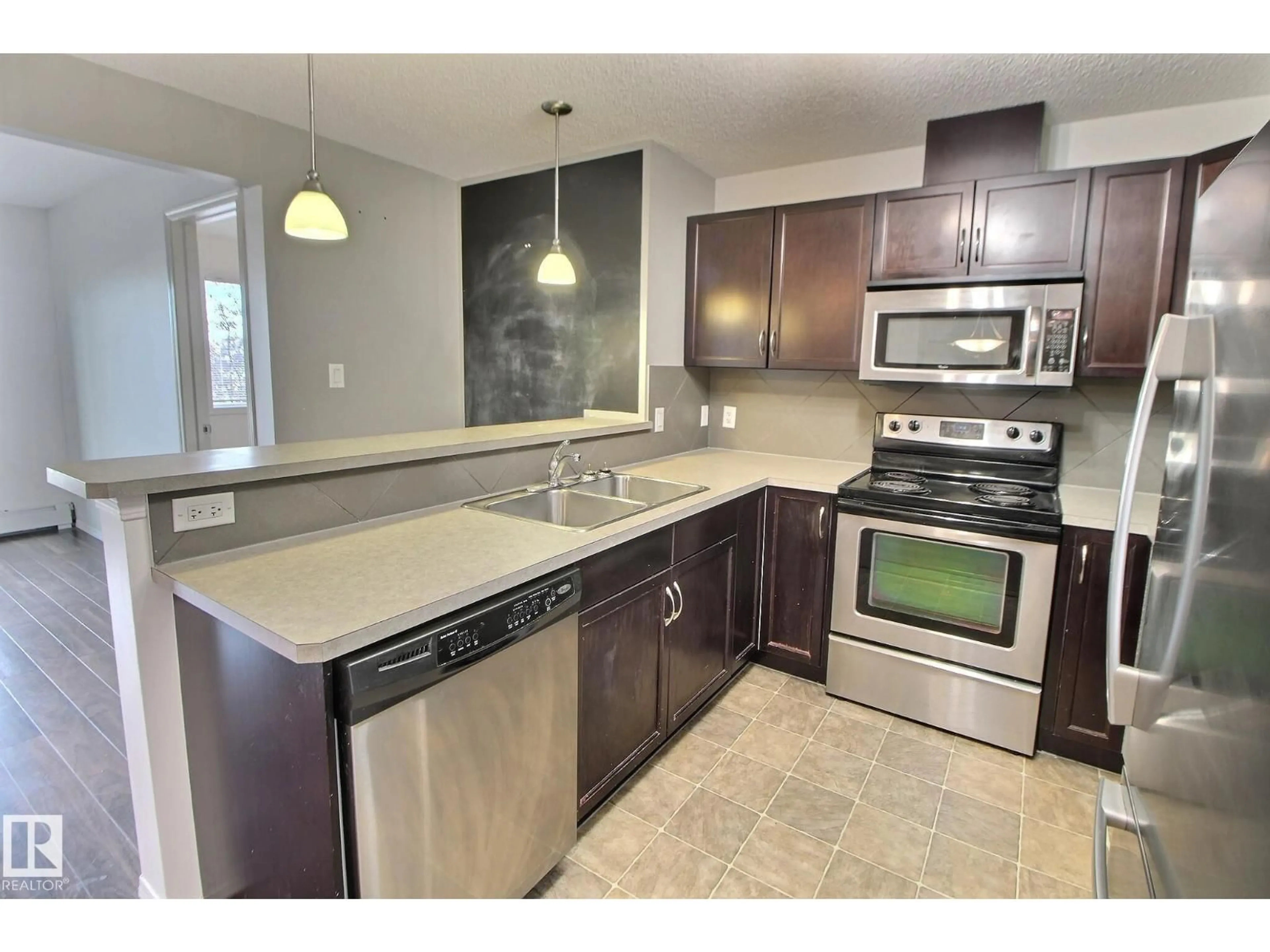 Open concept kitchen, ceramic/tile floor for 205 5951 165 AV NW, Edmonton Alberta T5Y0J6