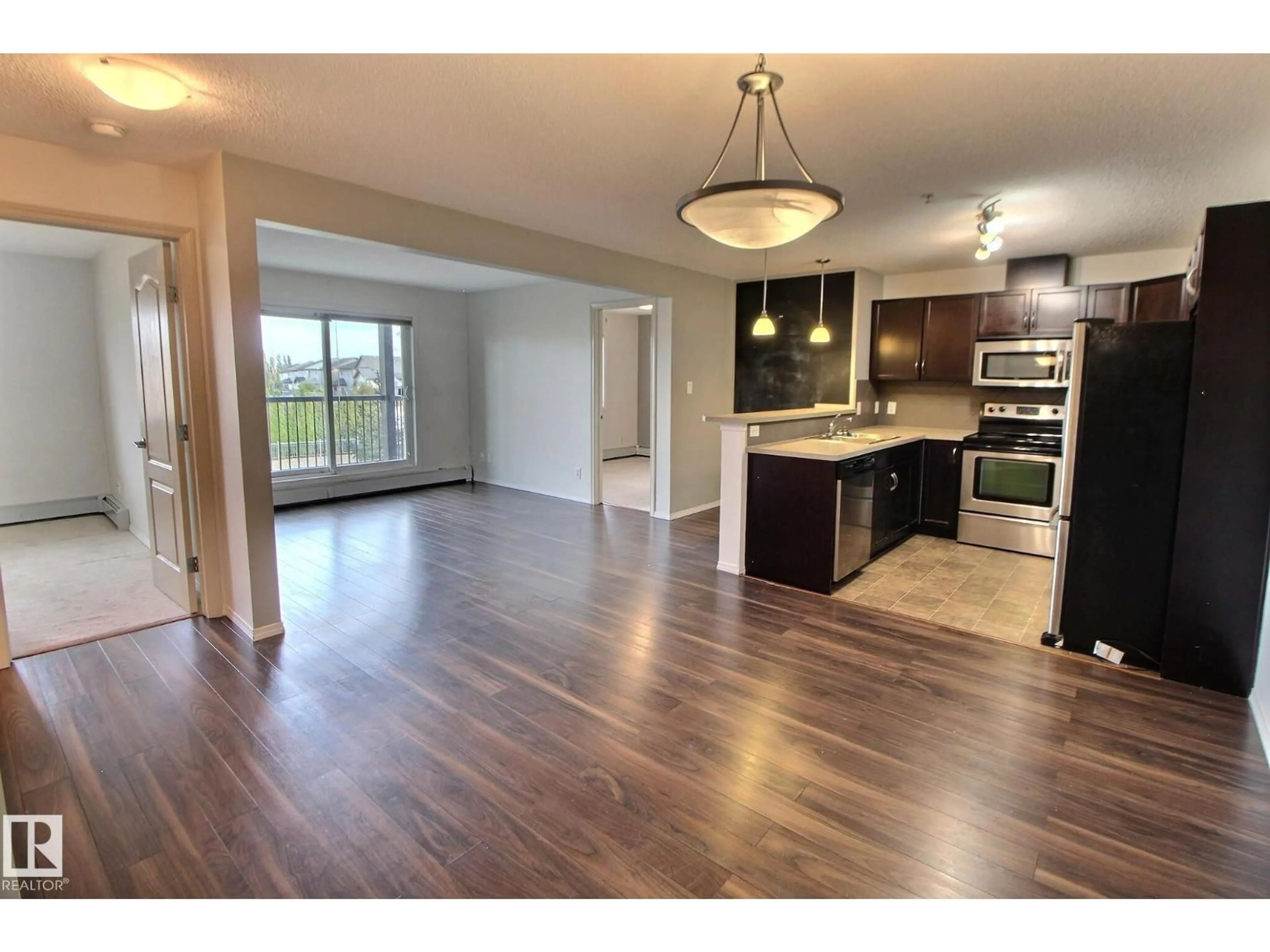 Open concept kitchen, wood/laminate floor for 205 5951 165 AV NW, Edmonton Alberta T5Y0J6
