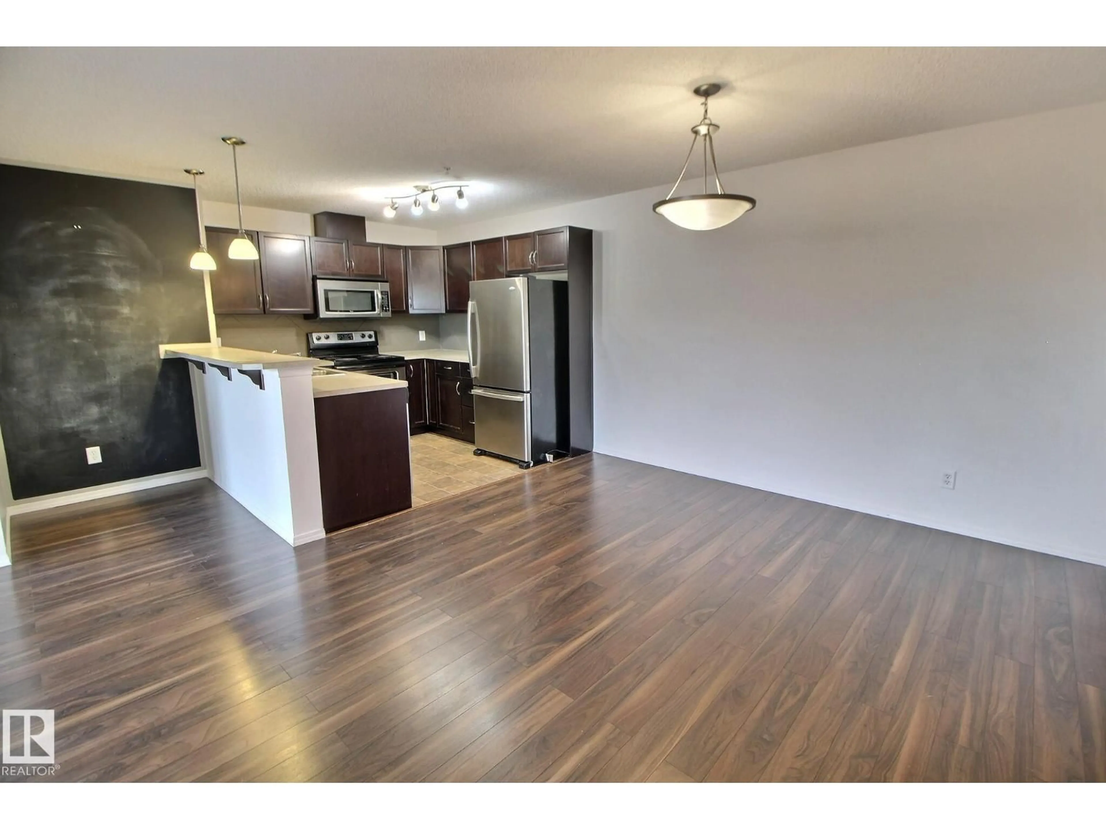 Open concept kitchen, wood/laminate floor for 205 5951 165 AV NW, Edmonton Alberta T5Y0J6