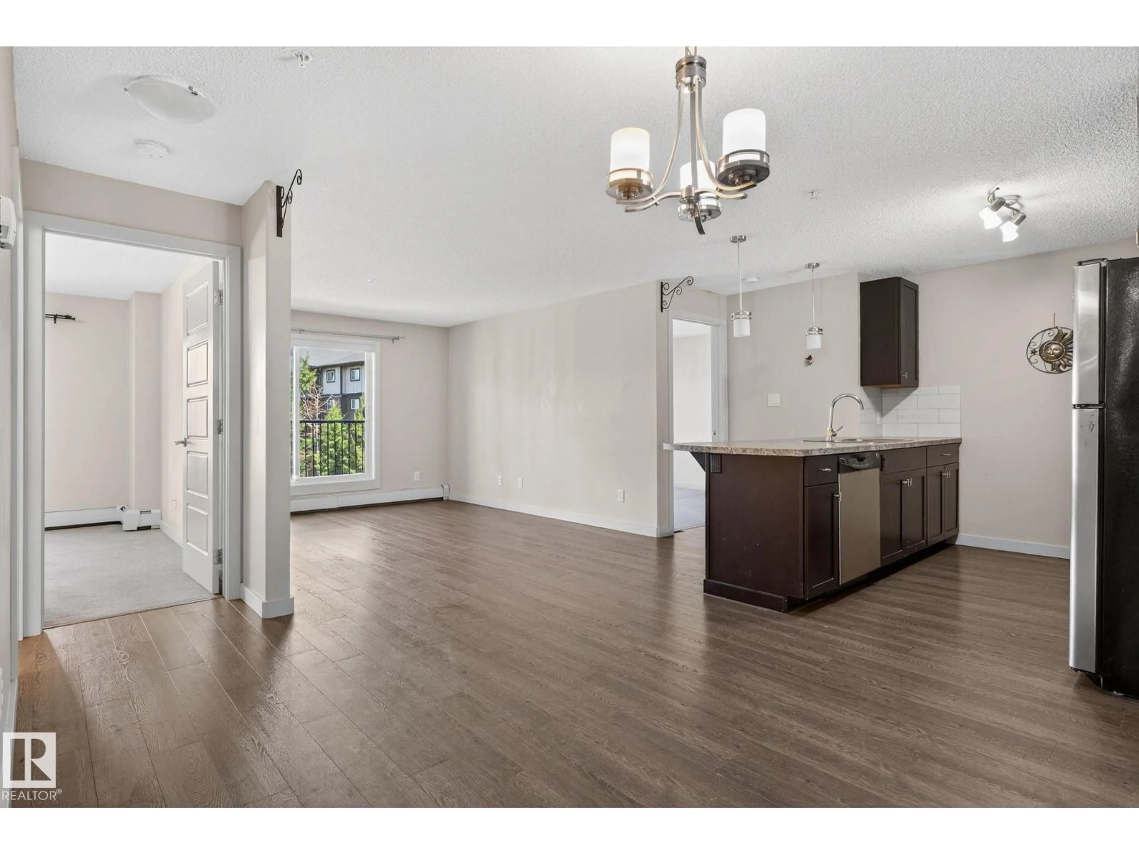 Open concept kitchen, wood/laminate floor for 304 - 6084 STANTON DR, Edmonton Alberta T6X0Z4