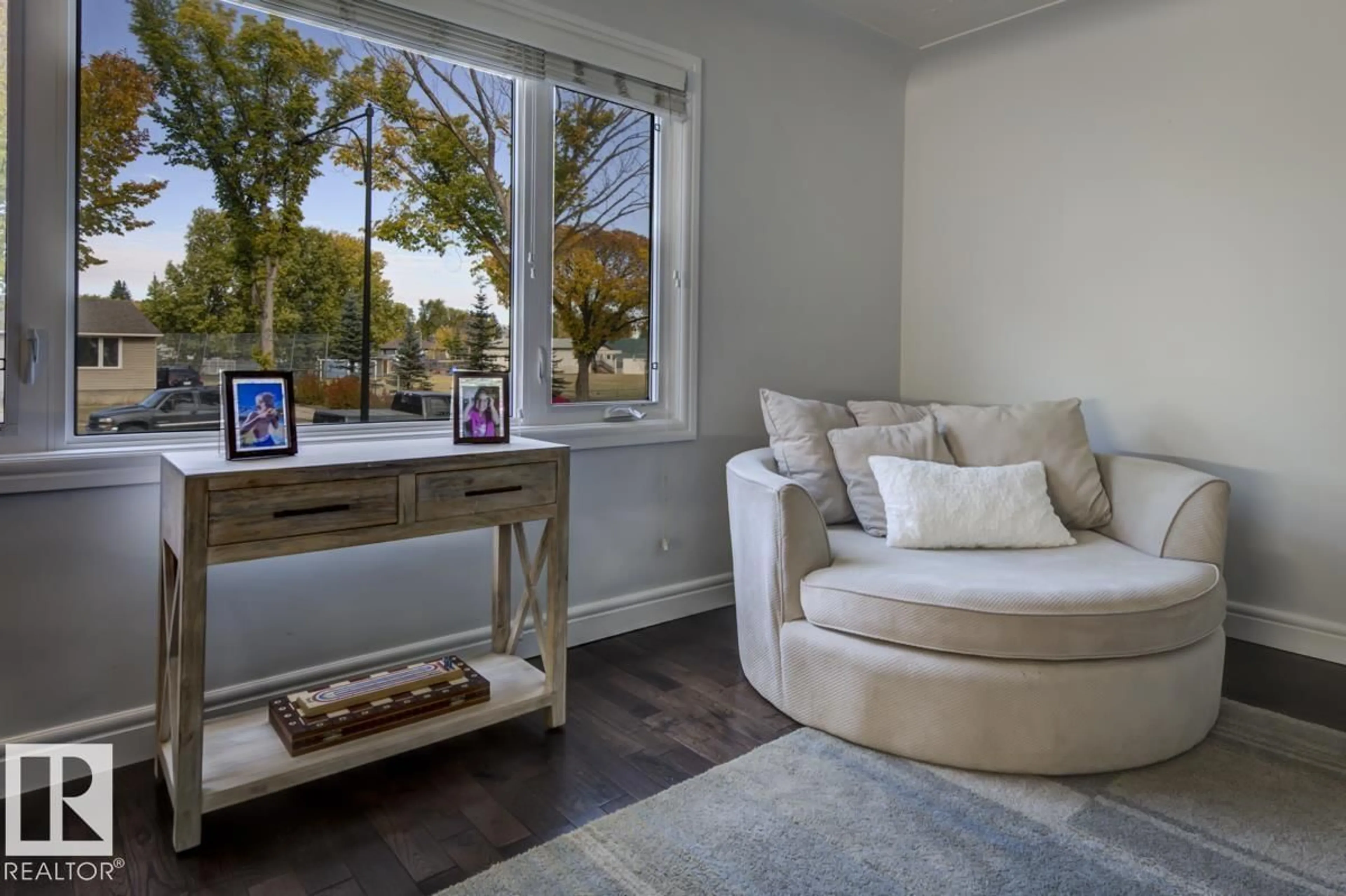 Living room with furniture, wood/laminate floor for 13619 122 AV, Edmonton Alberta T5L2W1