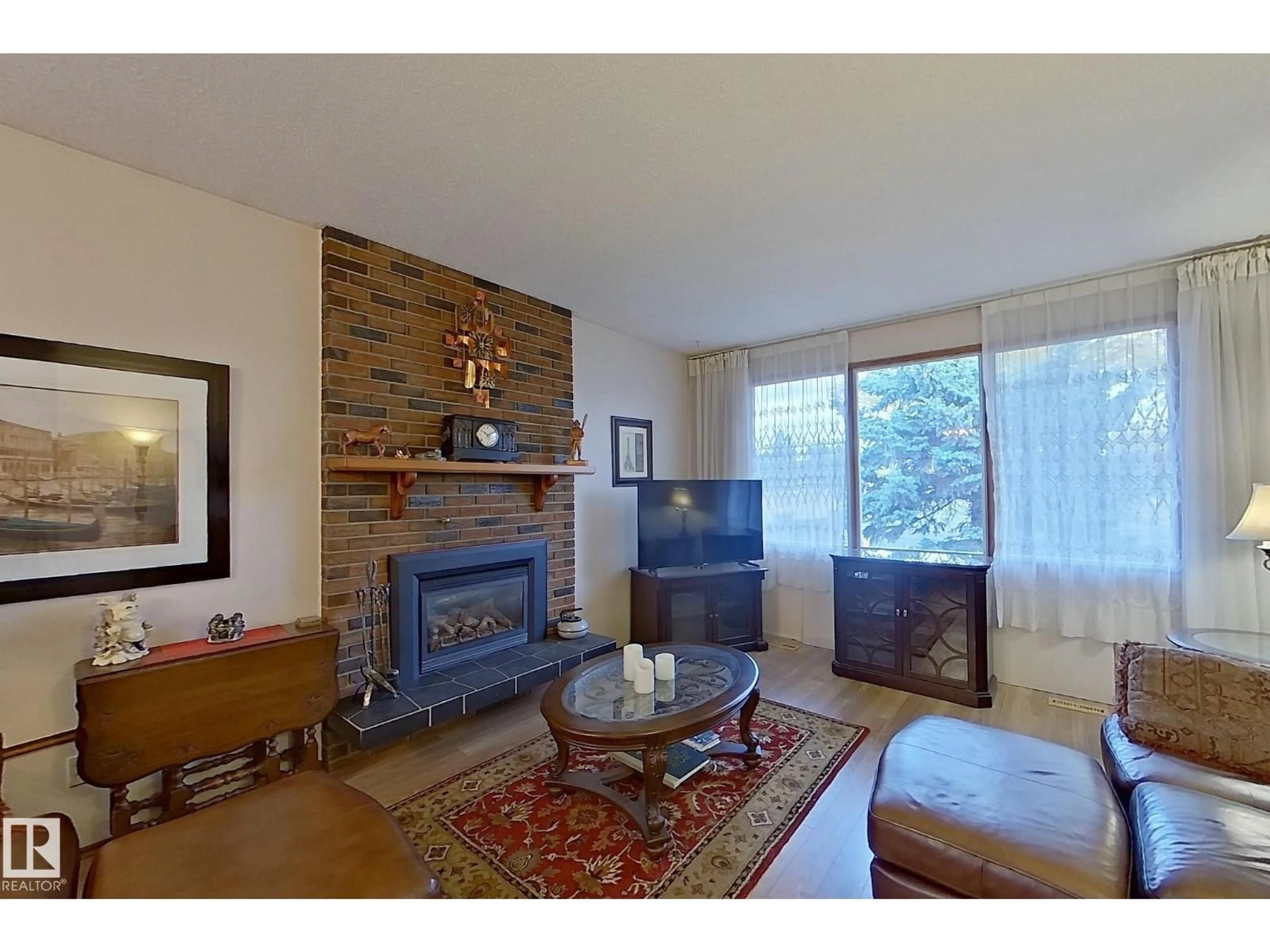 Living room with furniture, wood/laminate floor for 11455 162 AV, Edmonton Alberta T5X2L4