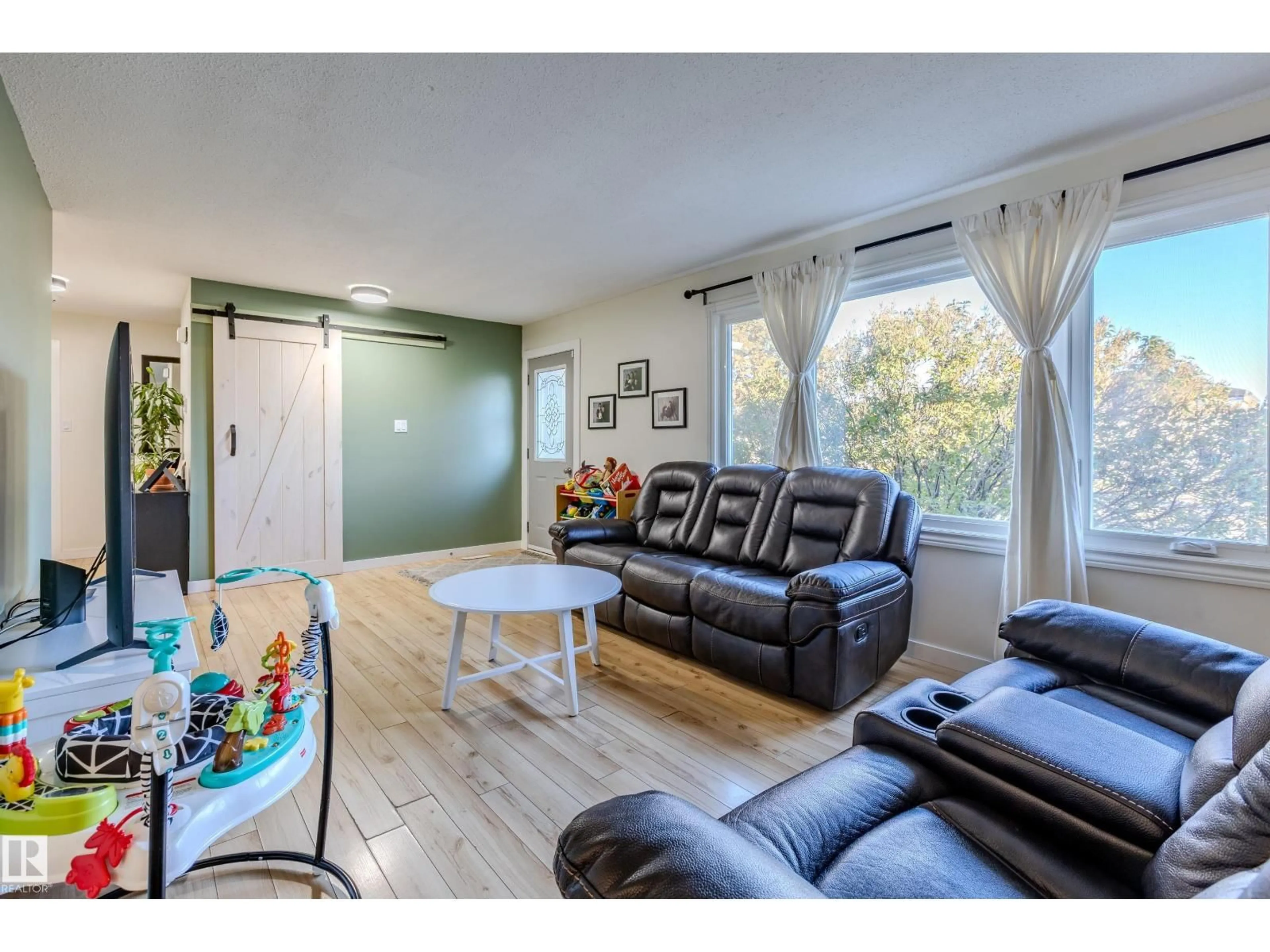 Living room with furniture, wood/laminate floor for 9713 100 AV, Morinville Alberta T8R1G6