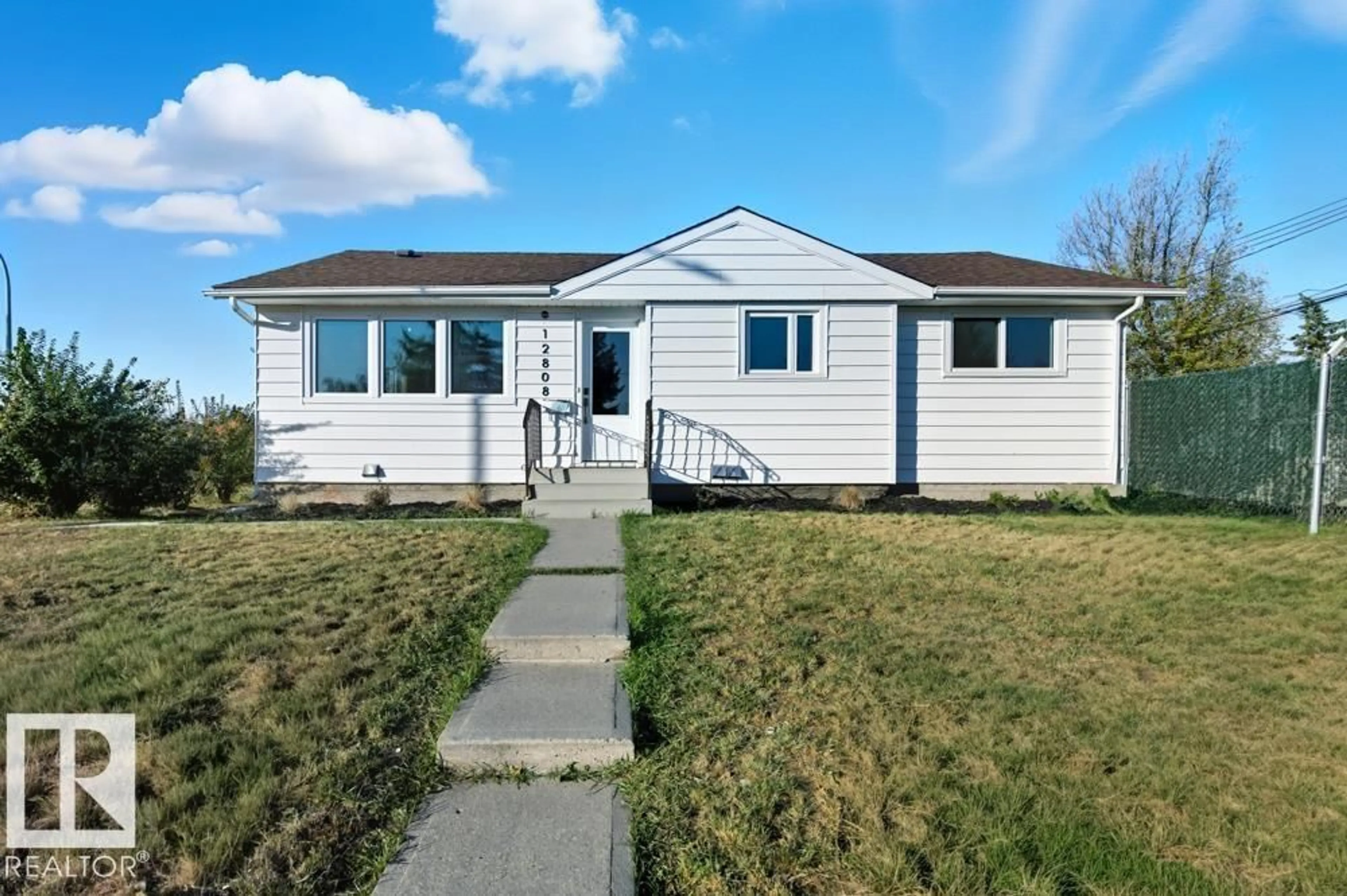 Home with vinyl exterior material, street for 12808 133 AV, Edmonton Alberta T5L3S3