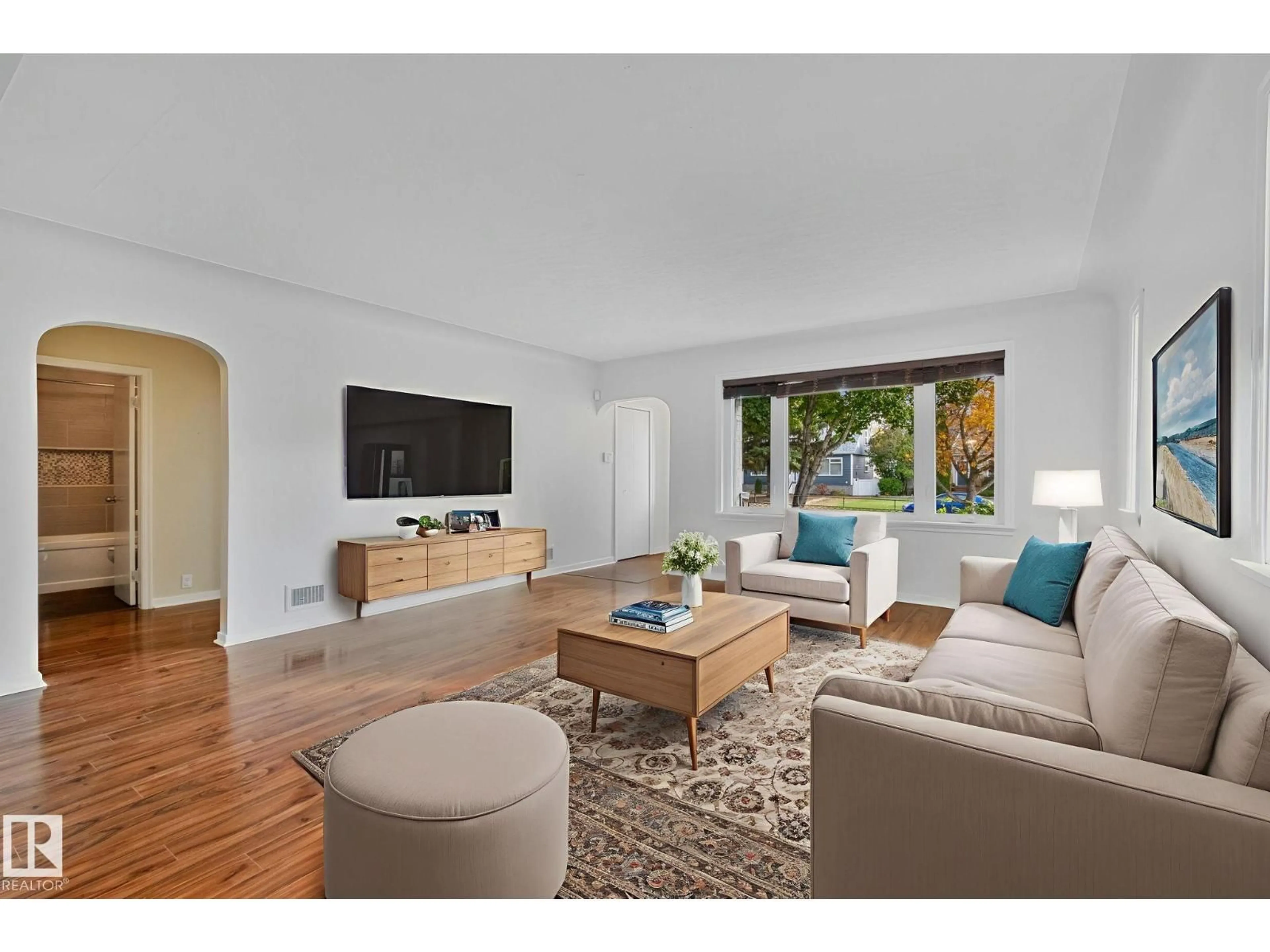 Living room with furniture, wood/laminate floor for NW - 10950 117 ST, Edmonton Alberta T5H3N6