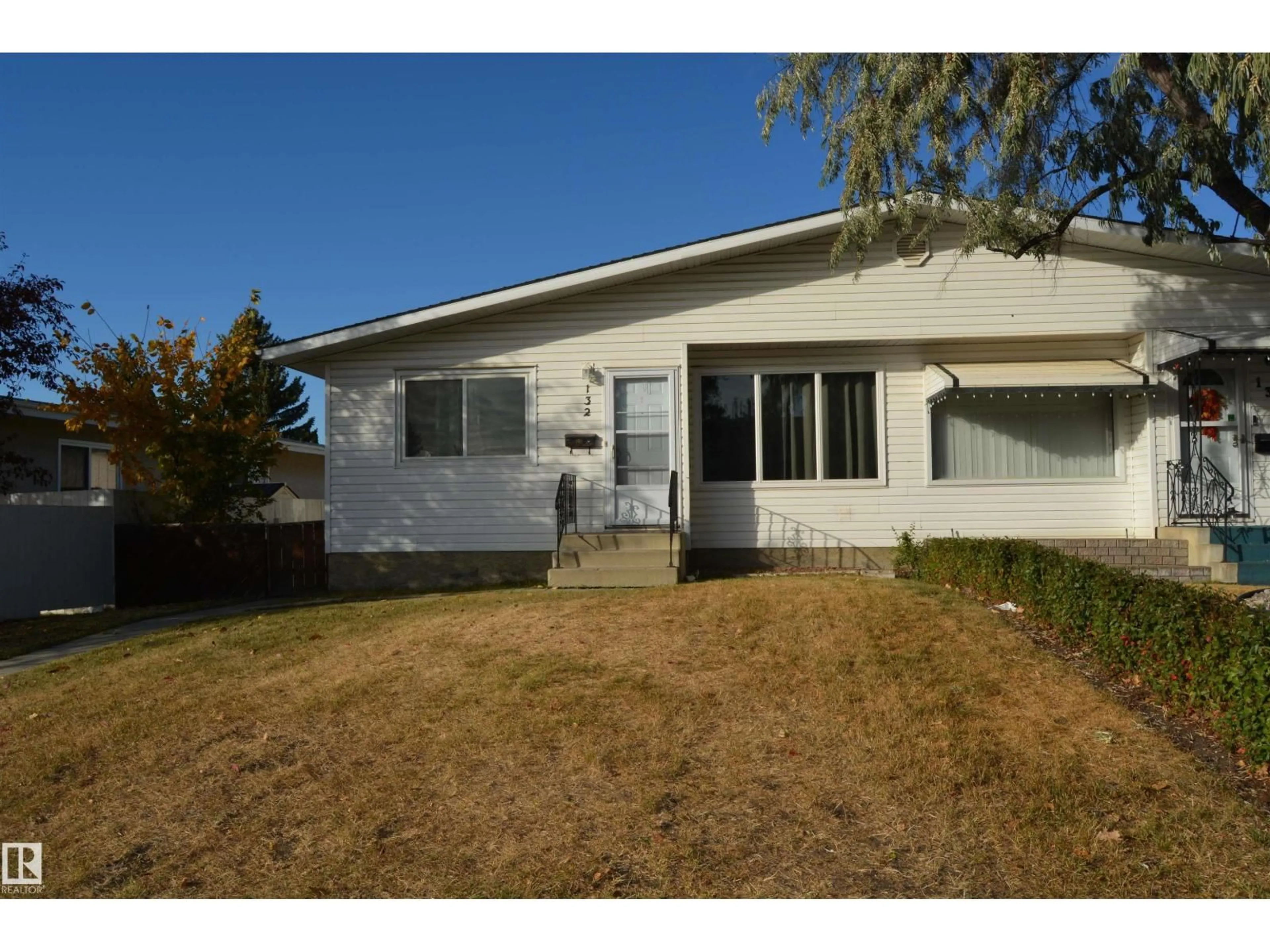 Home with vinyl exterior material, street for 132 MILLBOURNE RD E, Edmonton Alberta T6K0K9