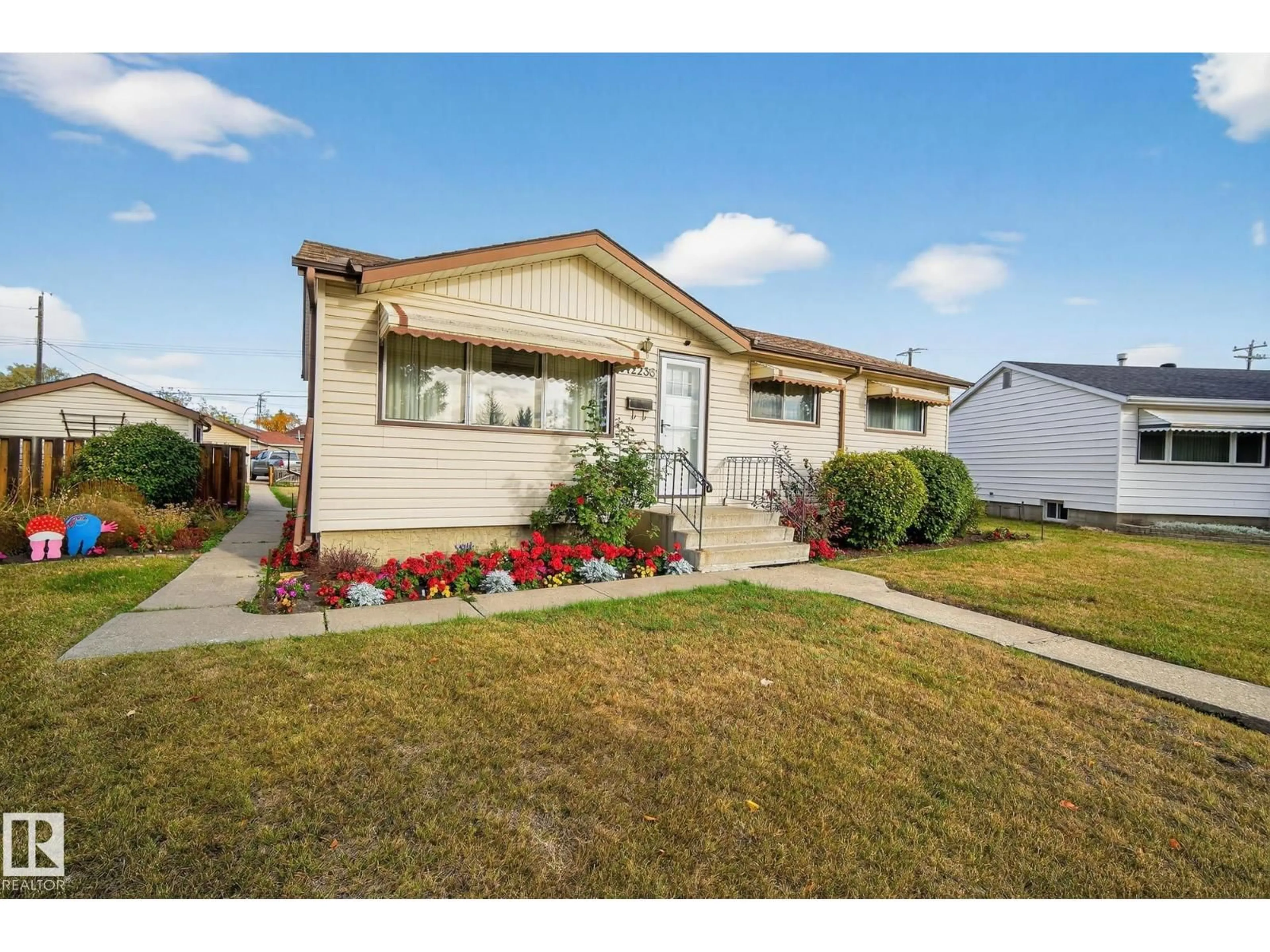 Home with vinyl exterior material, street for 12236 136 AV, Edmonton Alberta T5L4A6