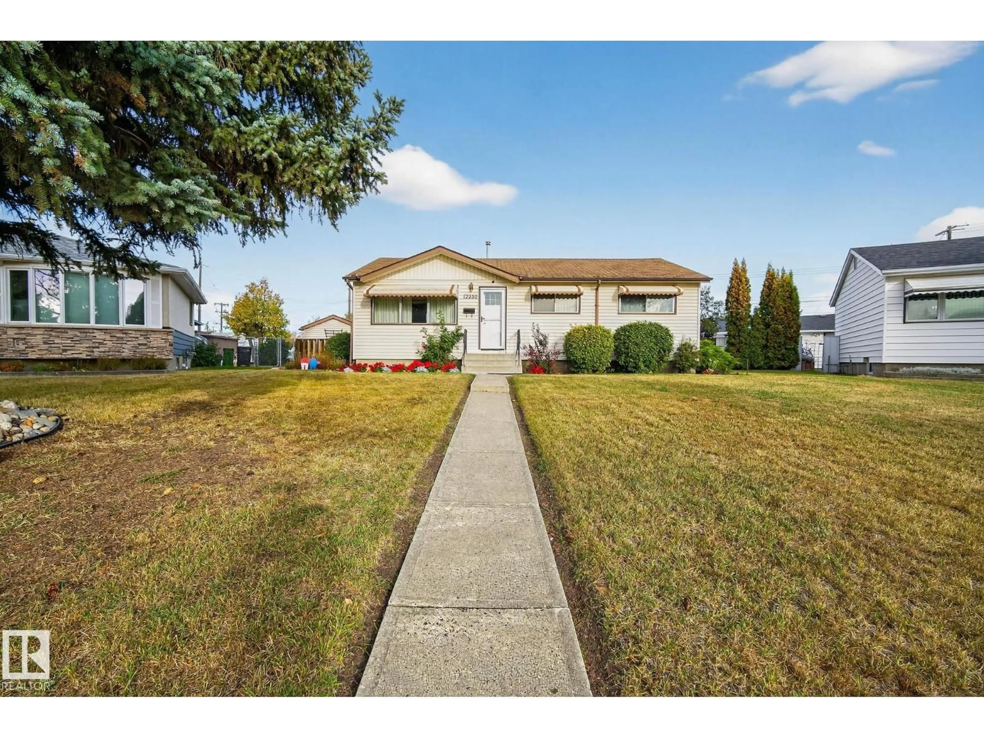 Home with vinyl exterior material, street for 12236 136 AV, Edmonton Alberta T5L4A6