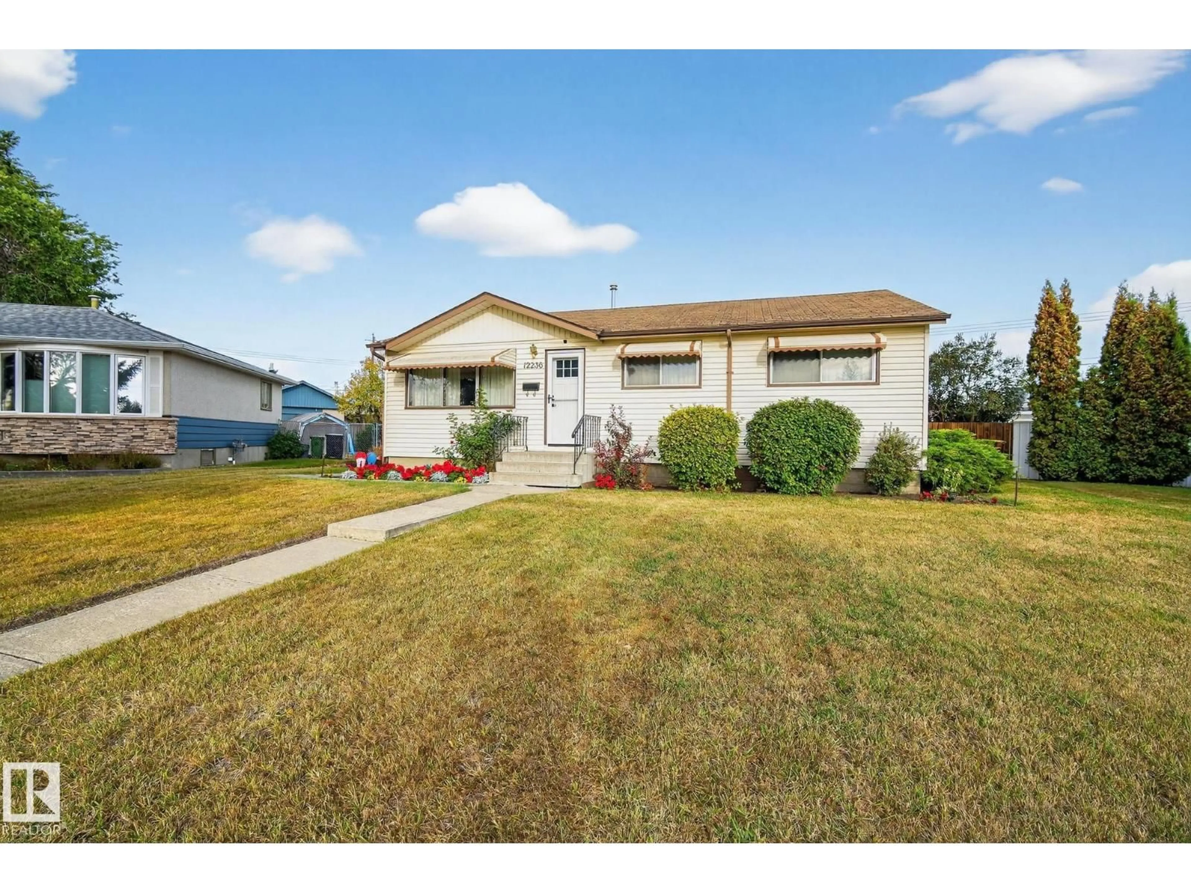 Home with vinyl exterior material, street for 12236 136 AV, Edmonton Alberta T5L4A6