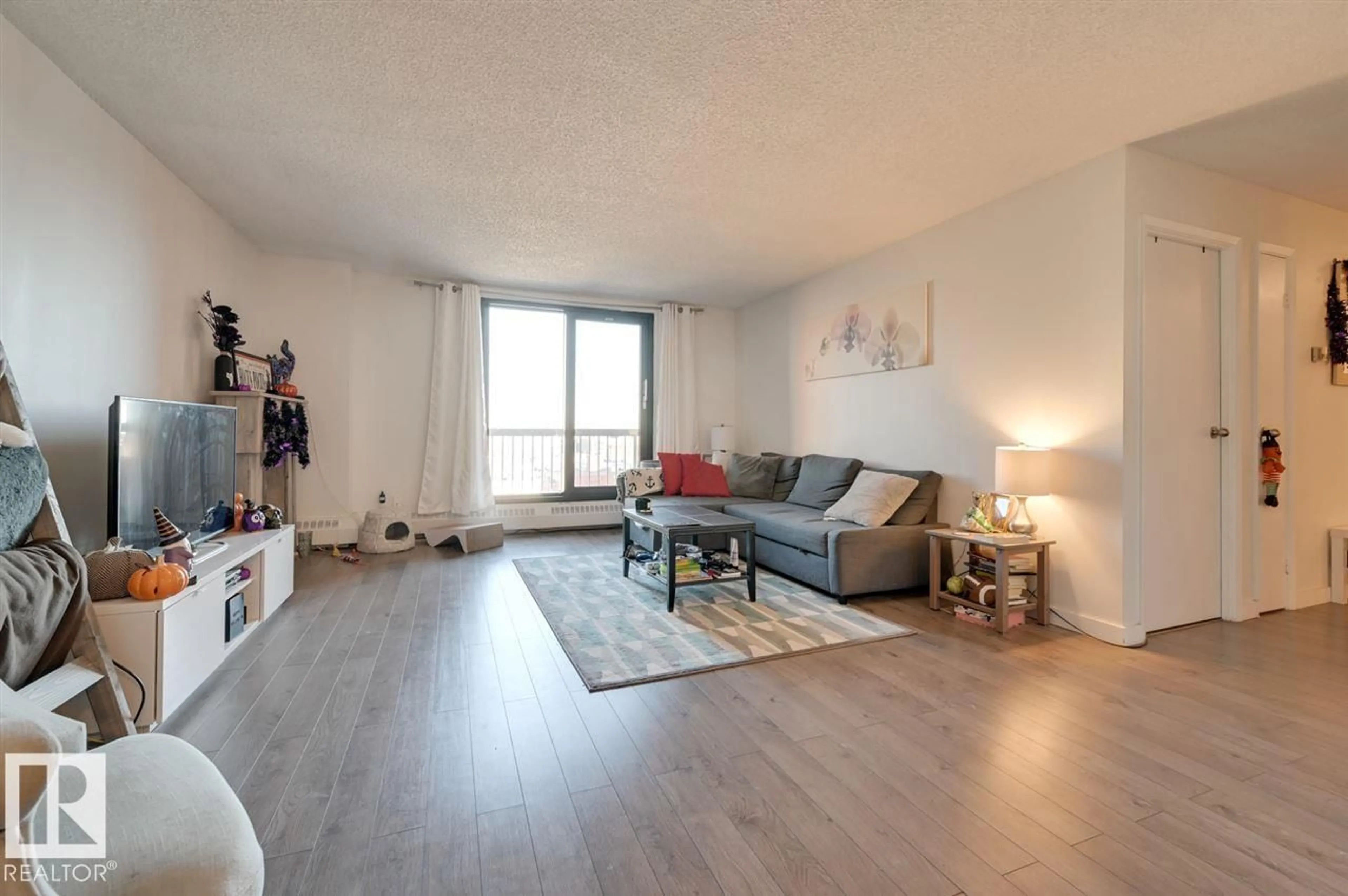 Living room with furniture, wood/laminate floor for 802 - 10175 109 ST, Edmonton Alberta T5J3P2