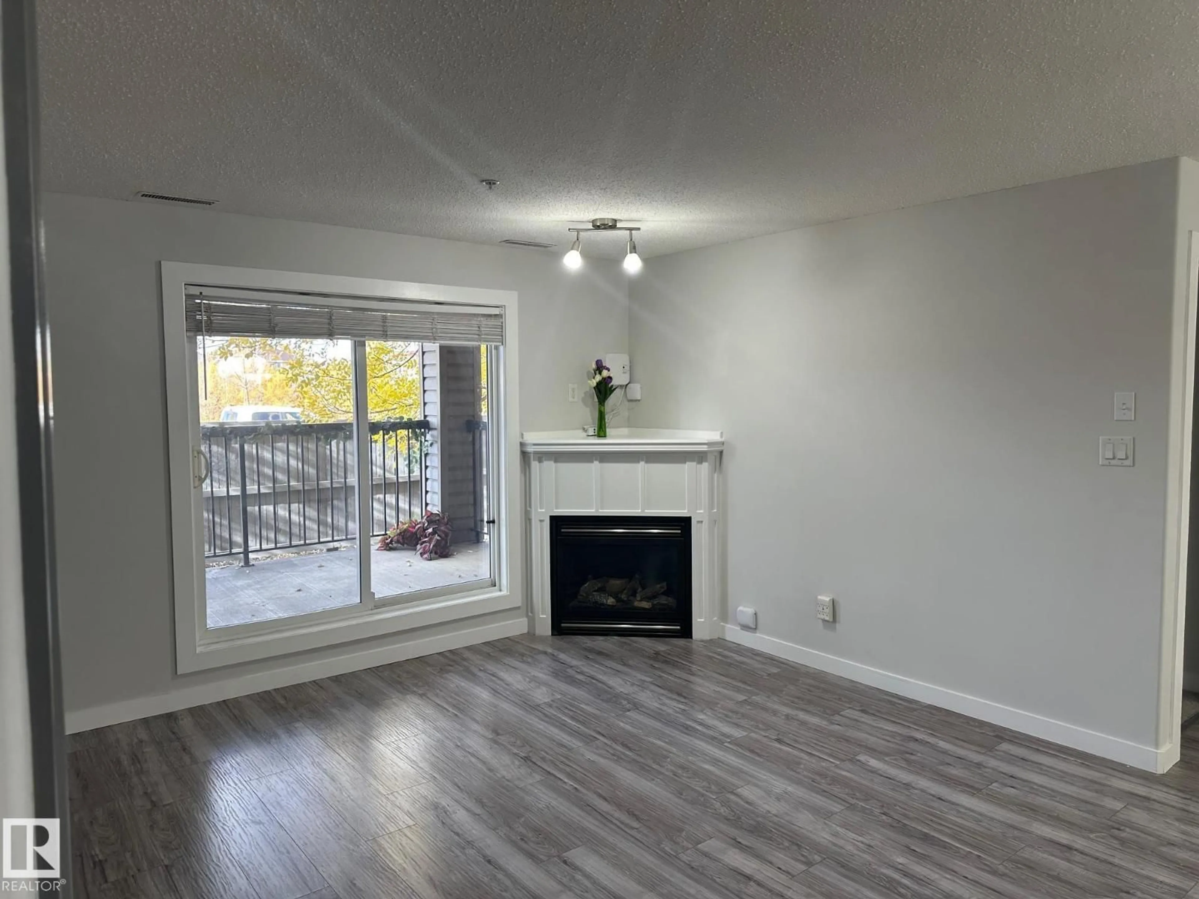 Living room with furniture, wood/laminate floor for 2098 - 115 BLACKMUD CREEK DR, Edmonton Alberta T6W1T7
