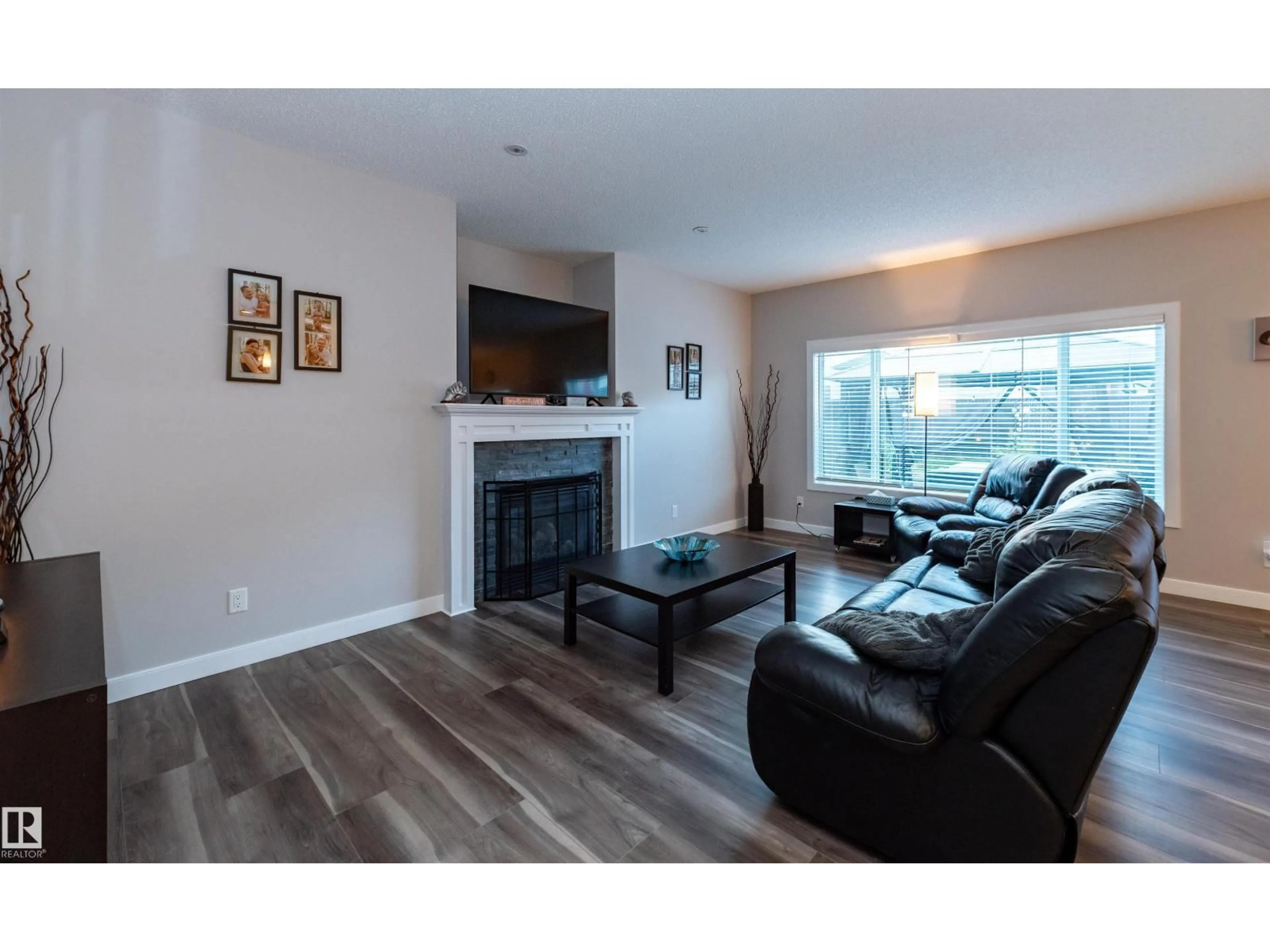 Living room with furniture, wood/laminate floor for NW - 16728 60 ST, Edmonton Alberta T5Y0W6