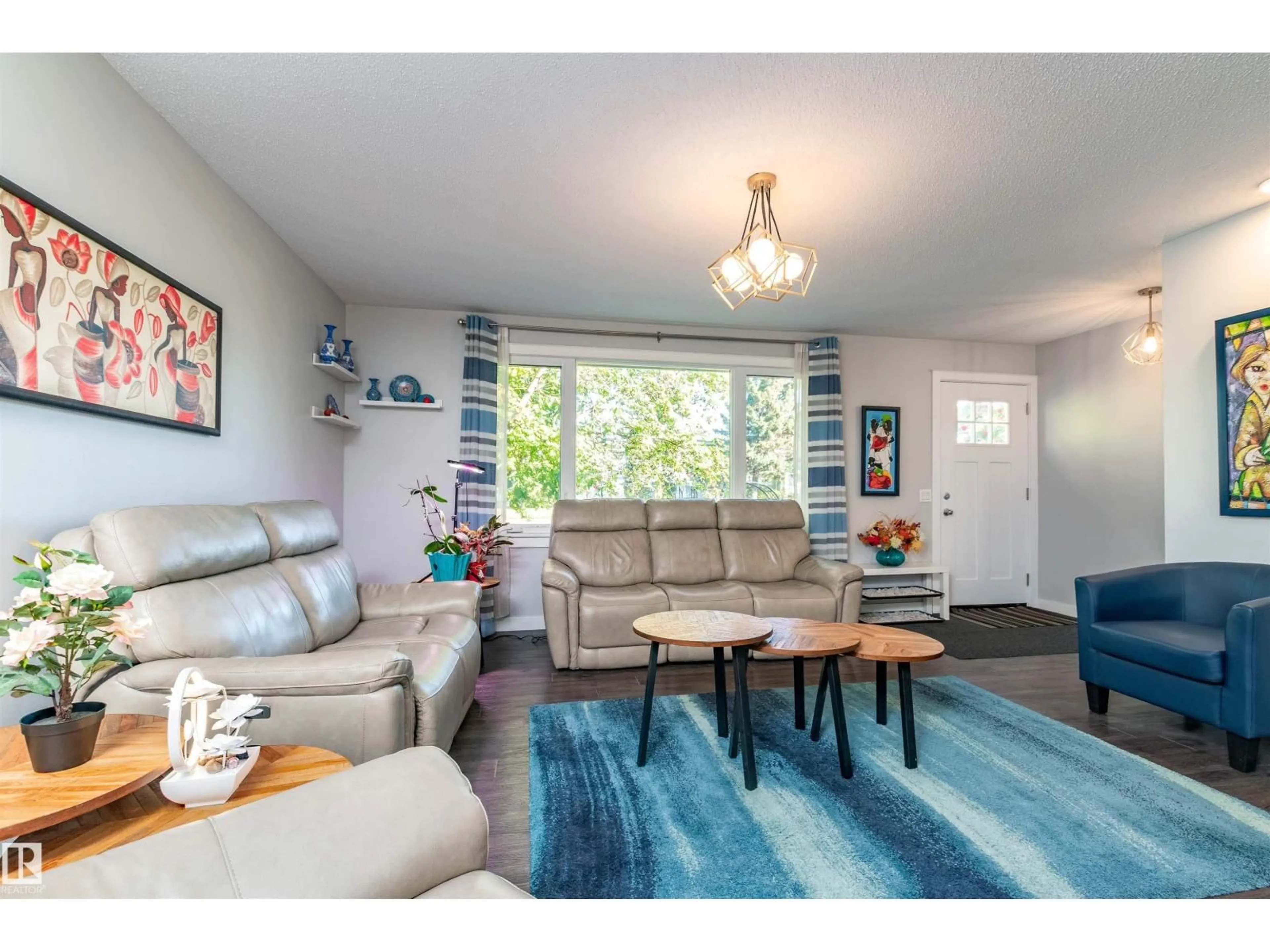 Living room with furniture, wood/laminate floor for 11227 40 AV, Edmonton Alberta T6J0P9