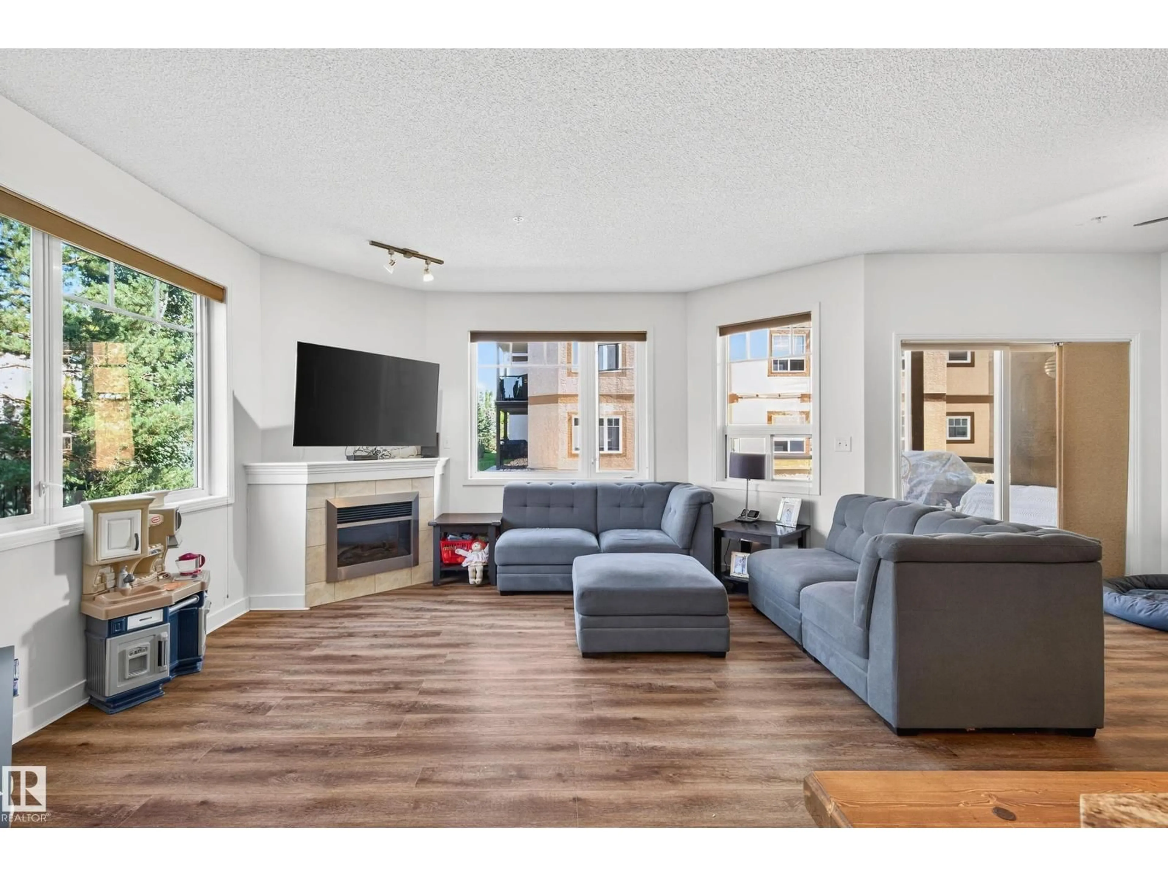 Living room with furniture, wood/laminate floor for #111 - 2035 GRANTHAM CO, Edmonton Alberta T5T3X4