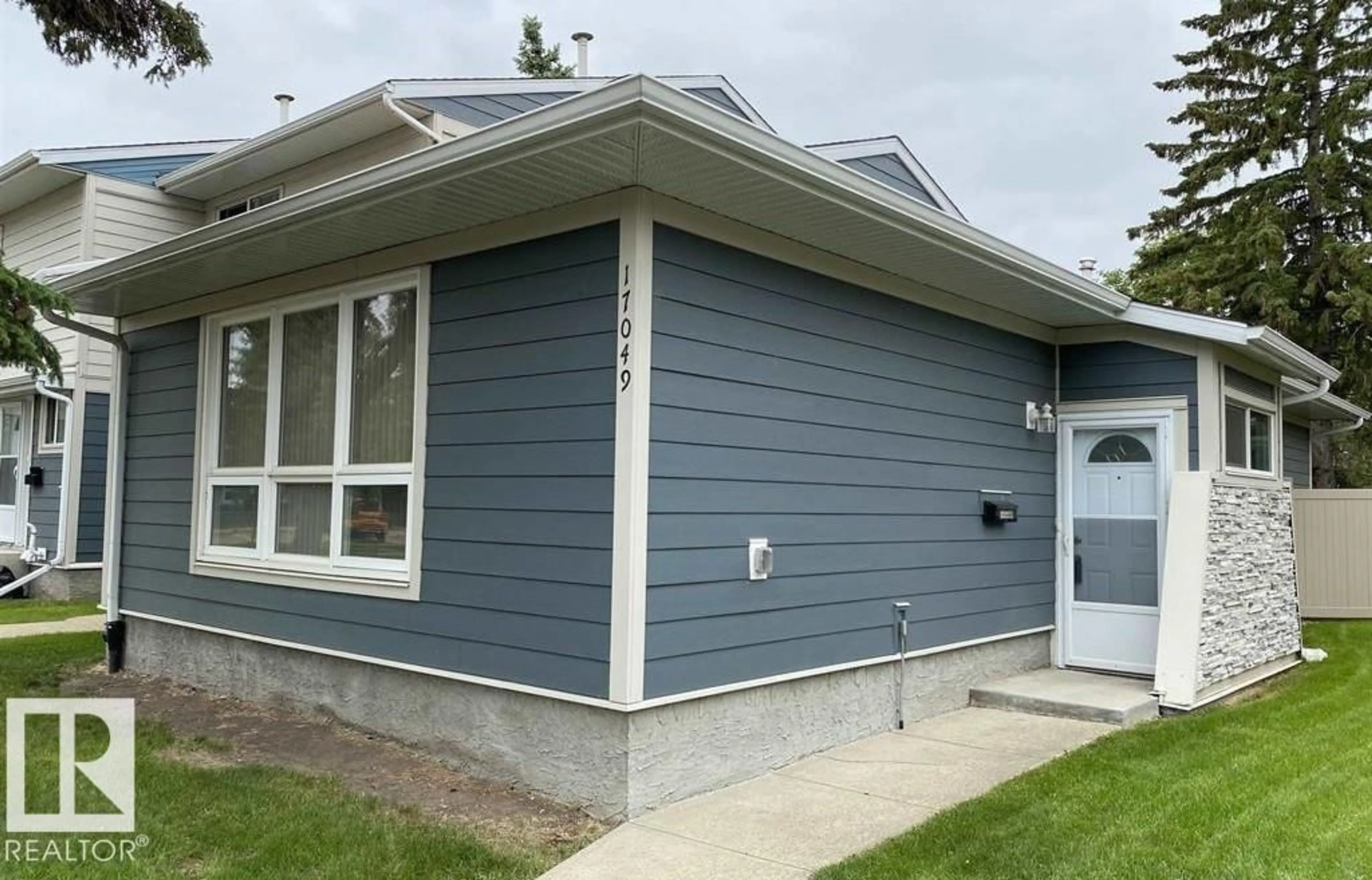 Home with vinyl exterior material, street for 17049 100 ST, Edmonton Alberta T5X4R8