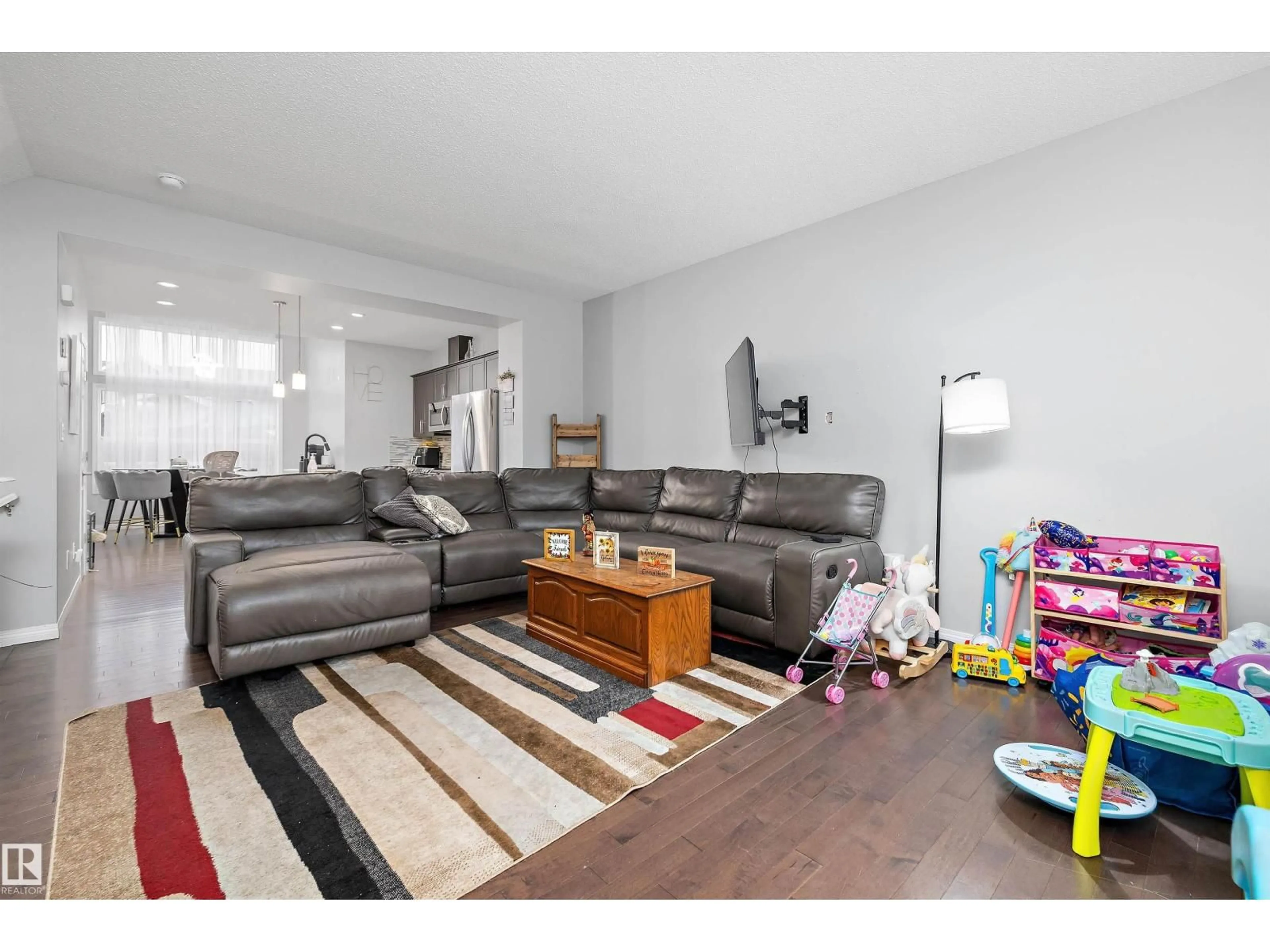 Living room with furniture, wood/laminate floor for 409 SIMPKINS LI, Leduc Alberta T9E1B8