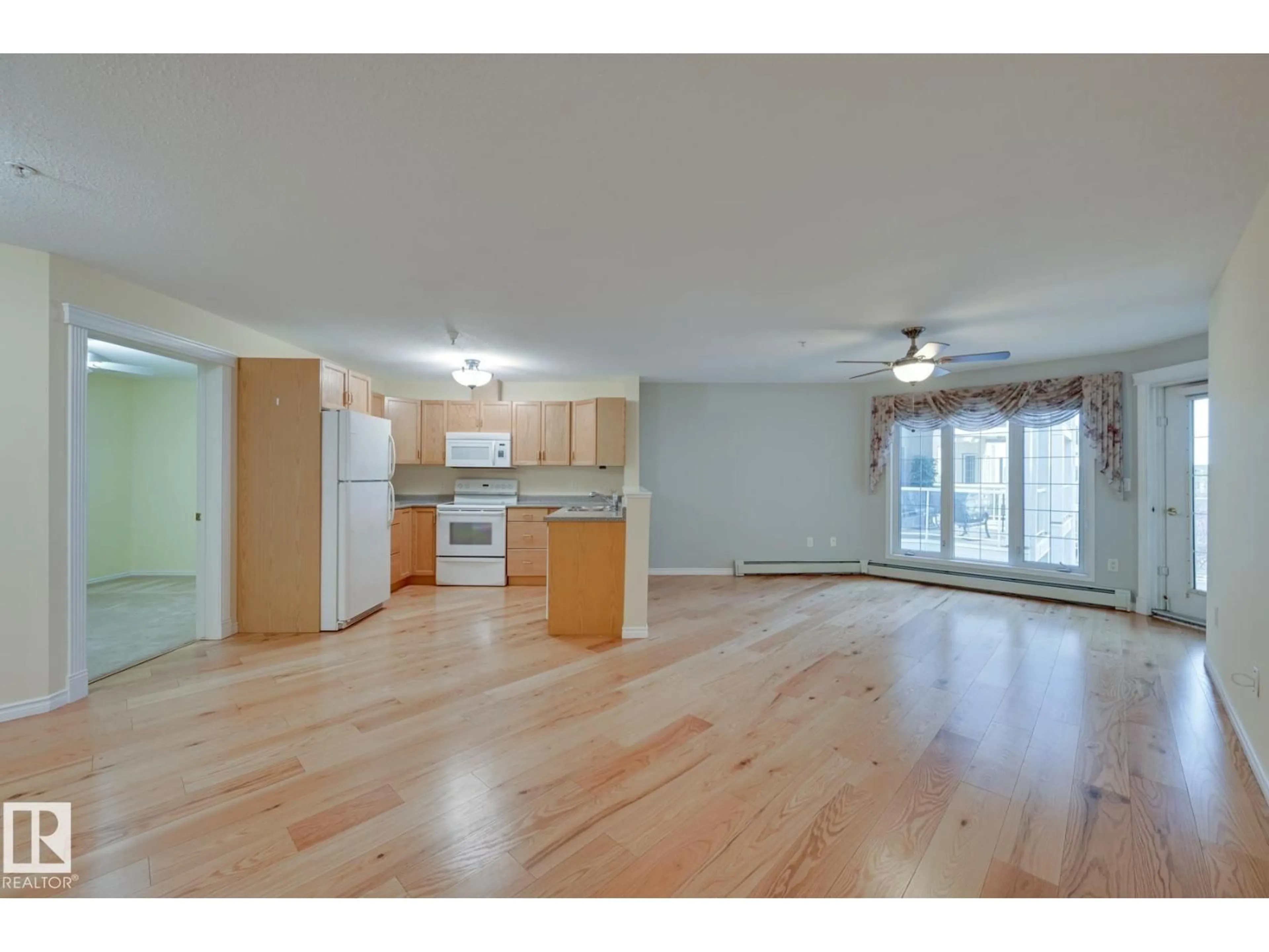 Open concept kitchen, wood/laminate floor for #315 - 2741 55 ST, Edmonton Alberta T6L7G7