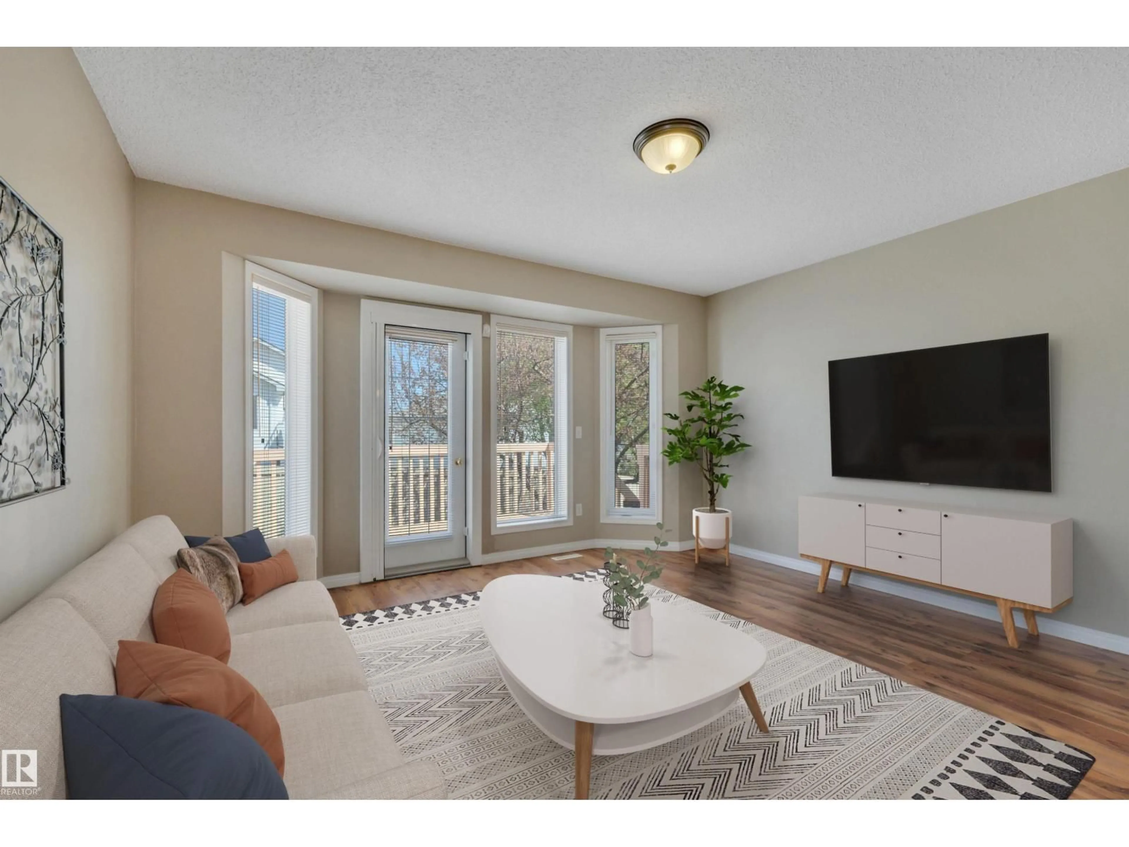 Living room with furniture, wood/laminate floor for 14428 MILLER BV, Edmonton Alberta T5Y2Y6