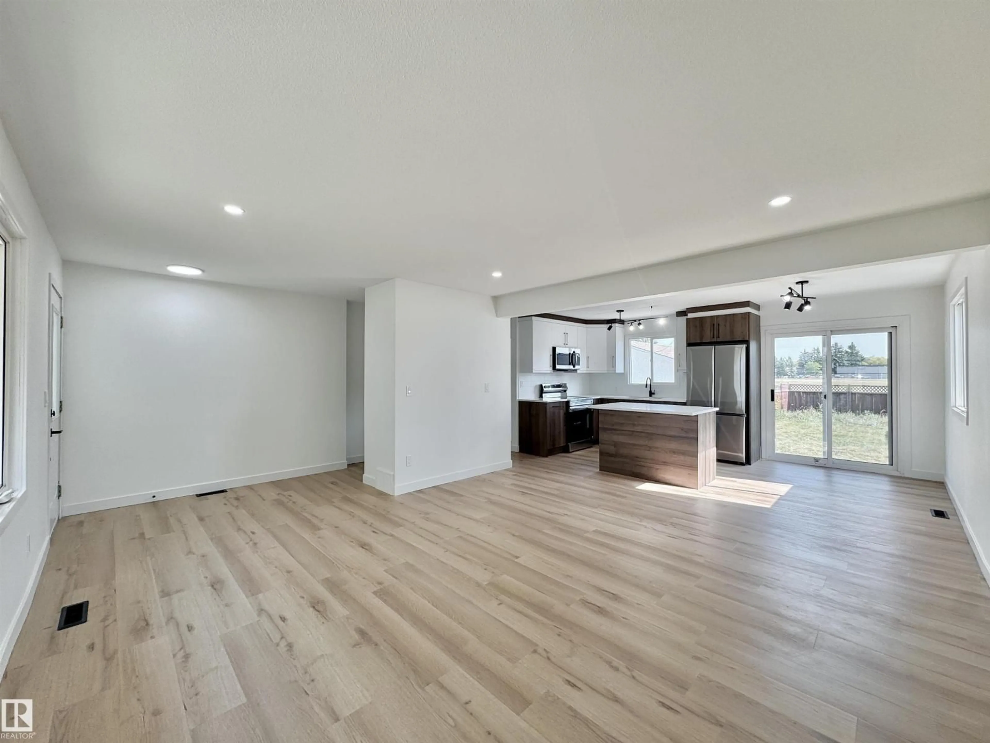 Open concept kitchen, wood/laminate floor for 9607 95 ST, Fort Saskatchewan Alberta T8L1R9