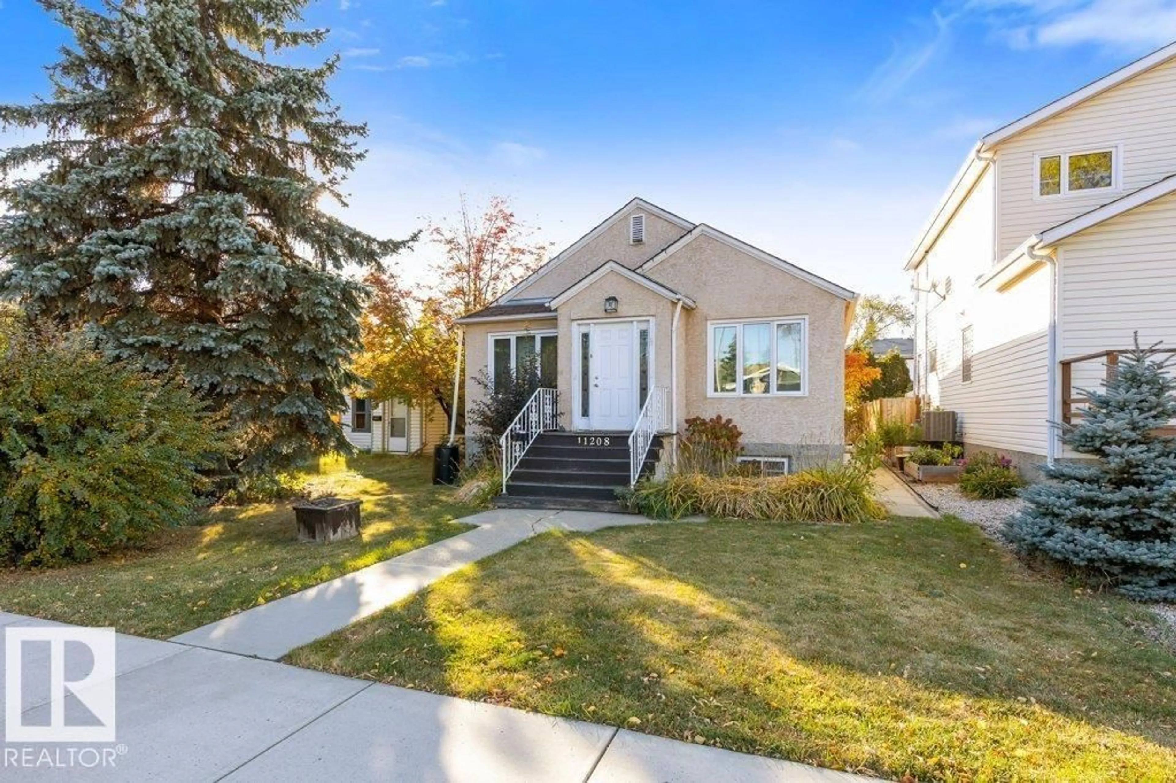 Home with vinyl exterior material, street for NW - 11208 79 ST, Edmonton Alberta T5B2J7