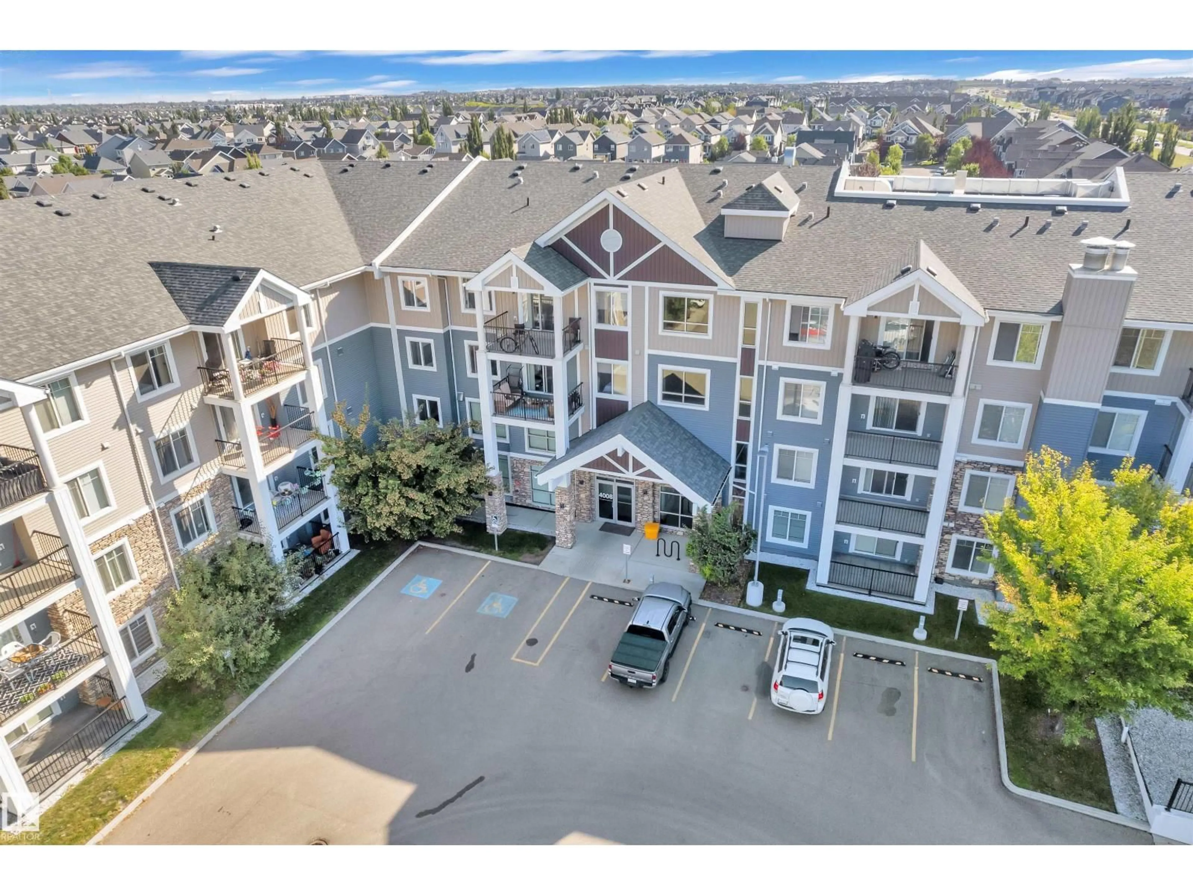 A pic from outside/outdoor area/front of a property/back of a property/a pic from drone, mountain view for #106 - 4008 SAVARYN DR, Edmonton Alberta T6X2E5