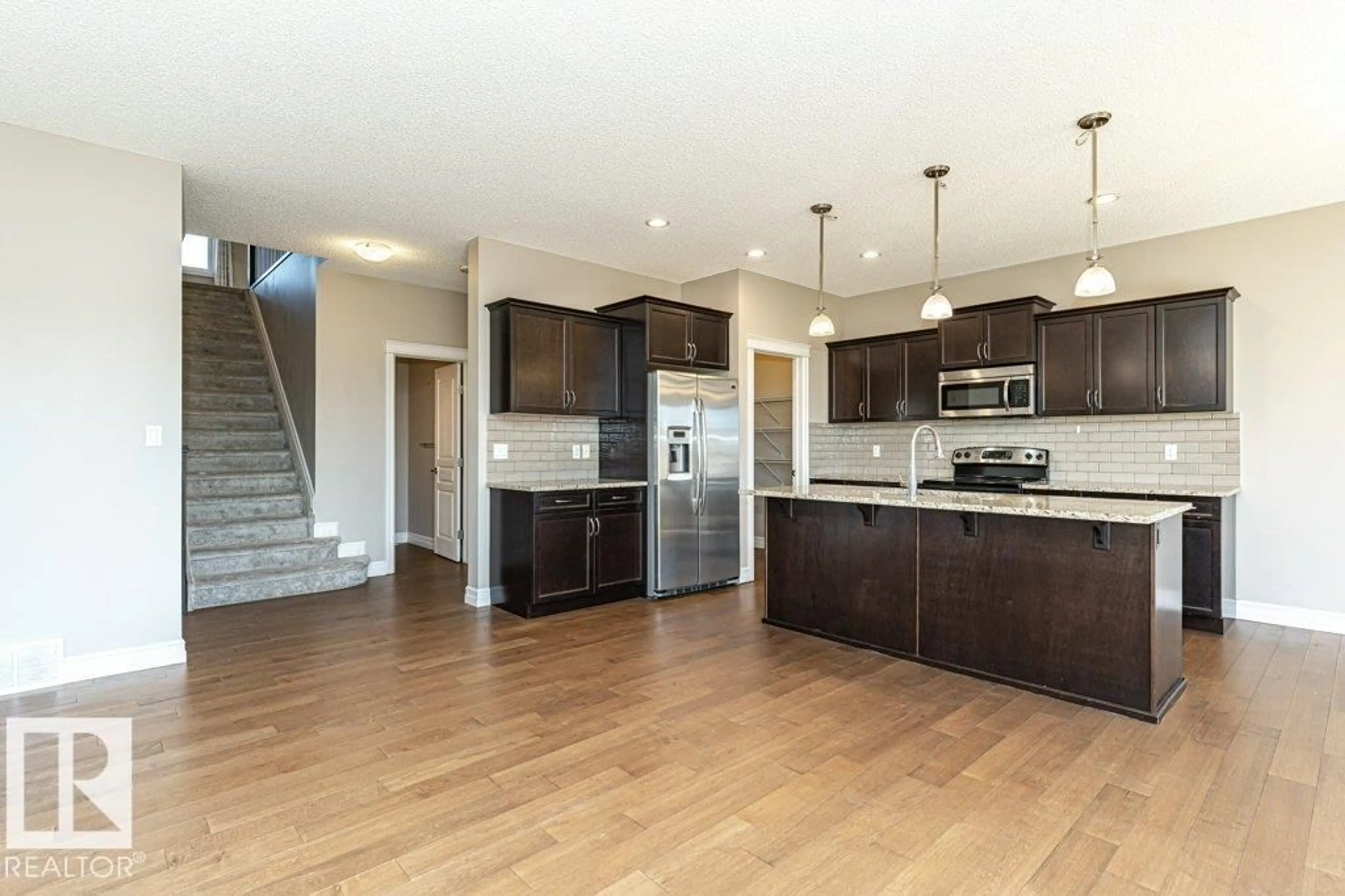 Open concept kitchen, wood/laminate floor for NW - 1920 33B ST, Edmonton Alberta T6T0L3