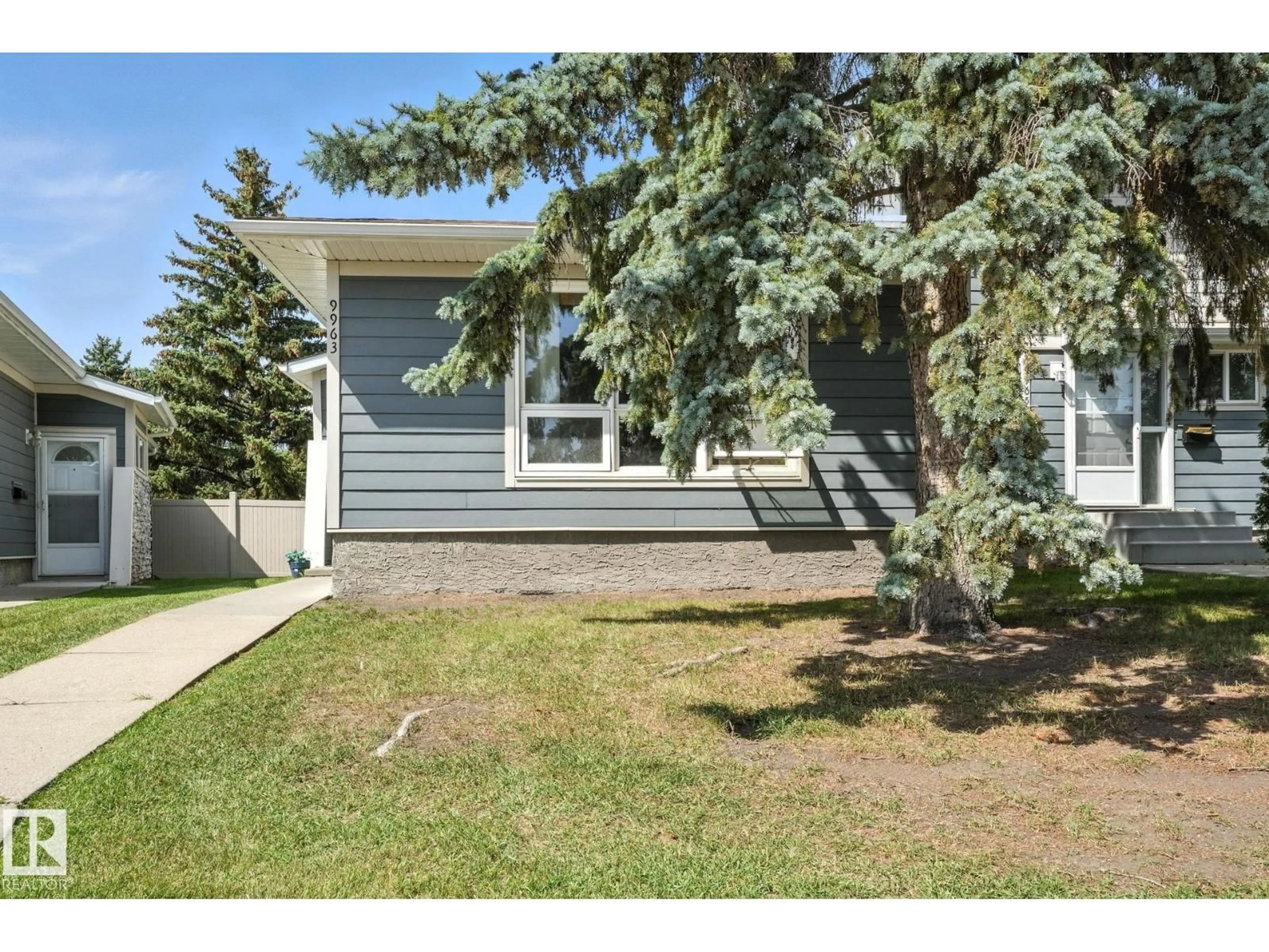 Home with vinyl exterior material, street for NW - 9963 171 AVE, Edmonton Alberta T5X4X2