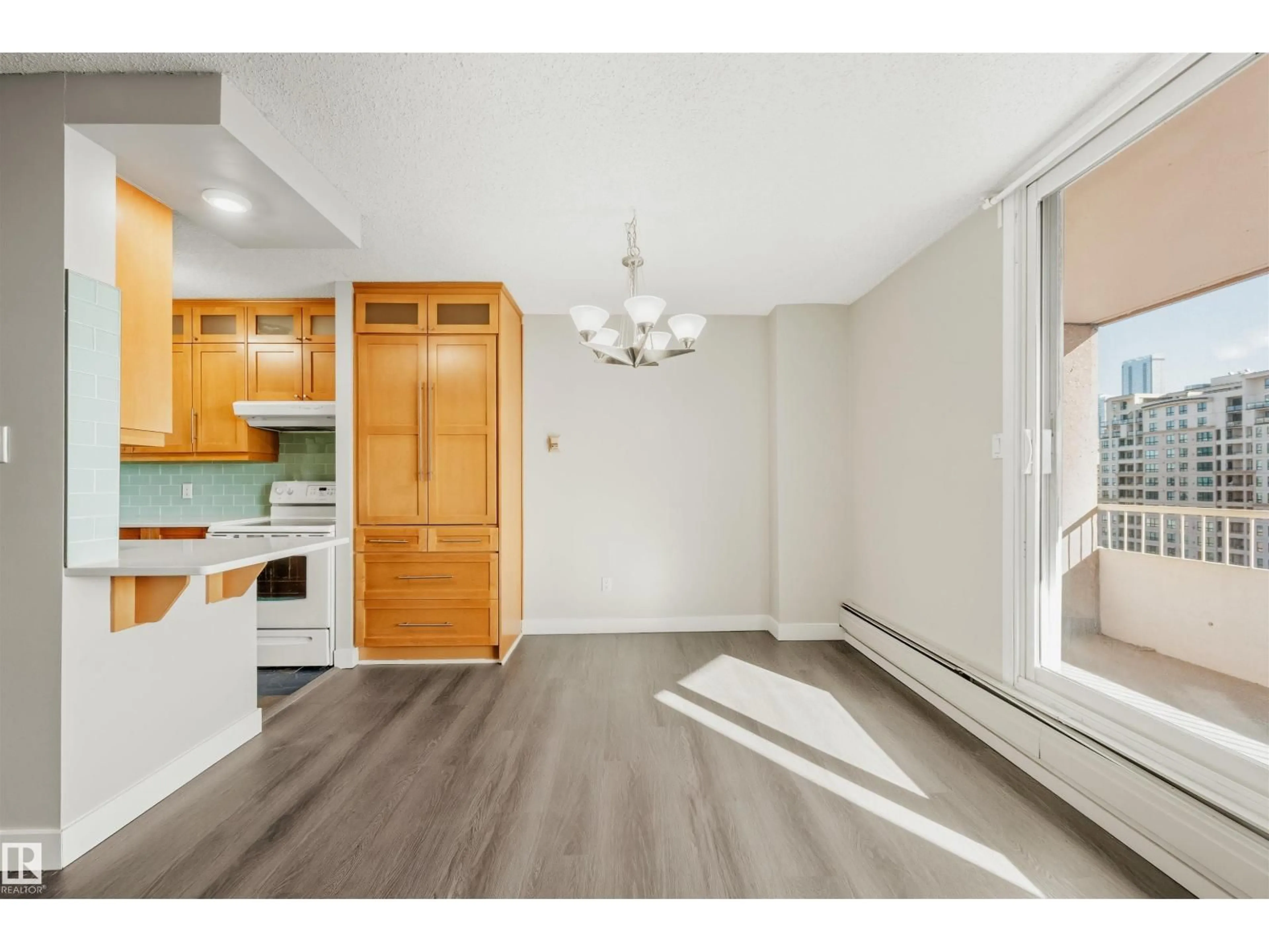 Open concept kitchen, wood/laminate floor for #1202 - 9909 110 ST, Edmonton Alberta T5K2E5